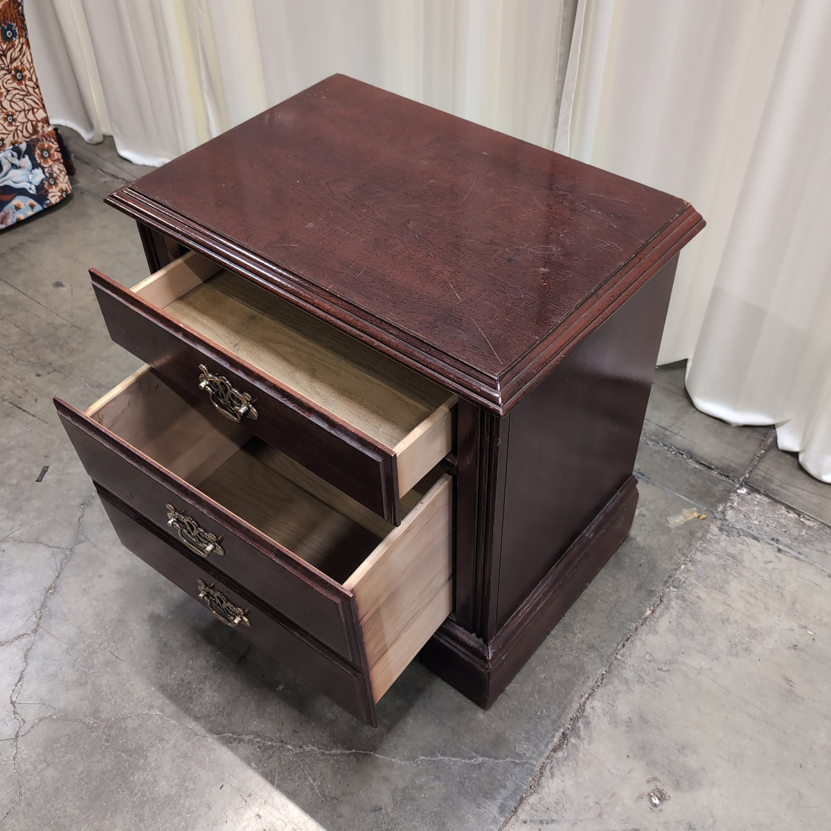 Traditional Dark Wood Three-Drawer Nightstand with Ornate Hardware