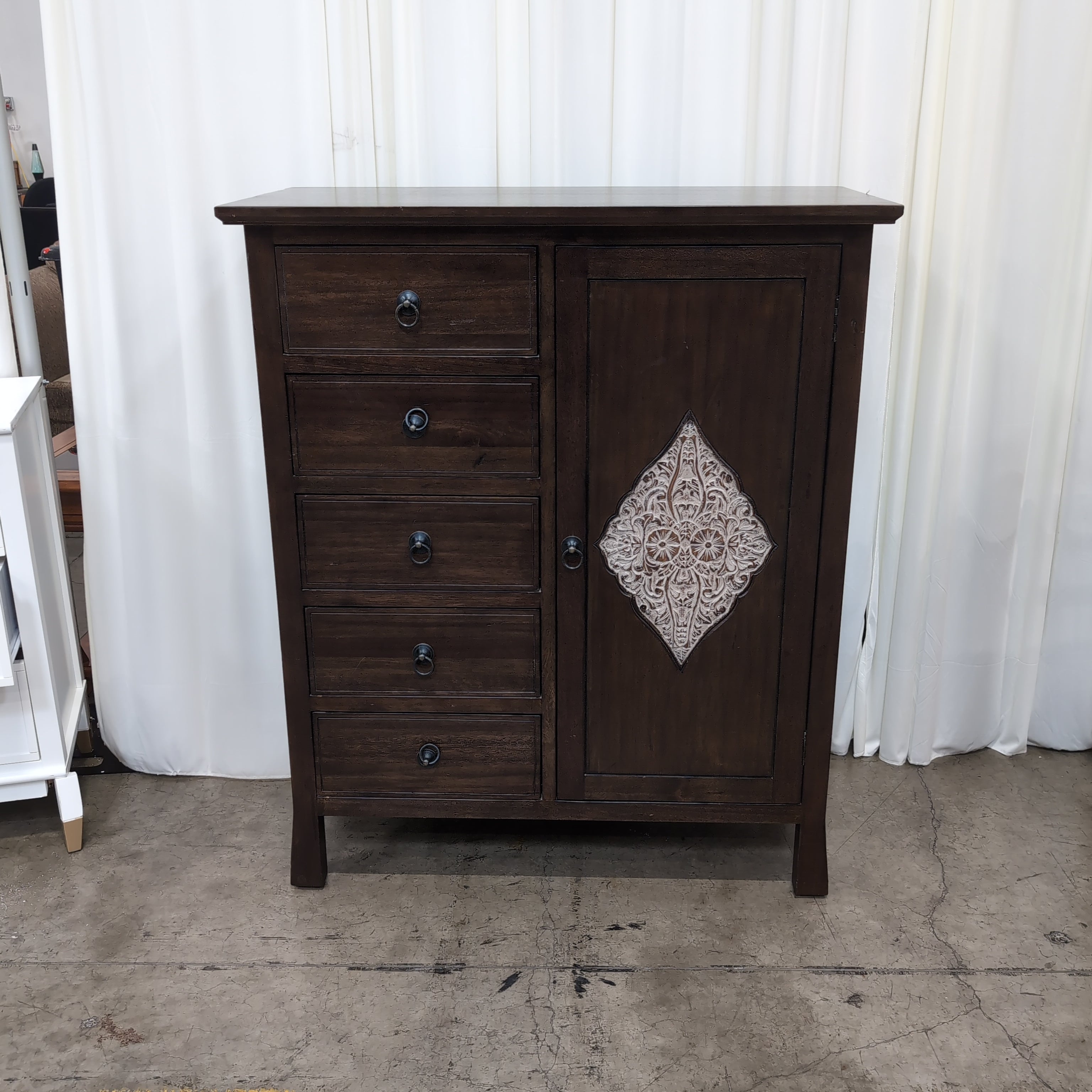 Dark Wood Five-Drawer Dresser with Ornate Panel