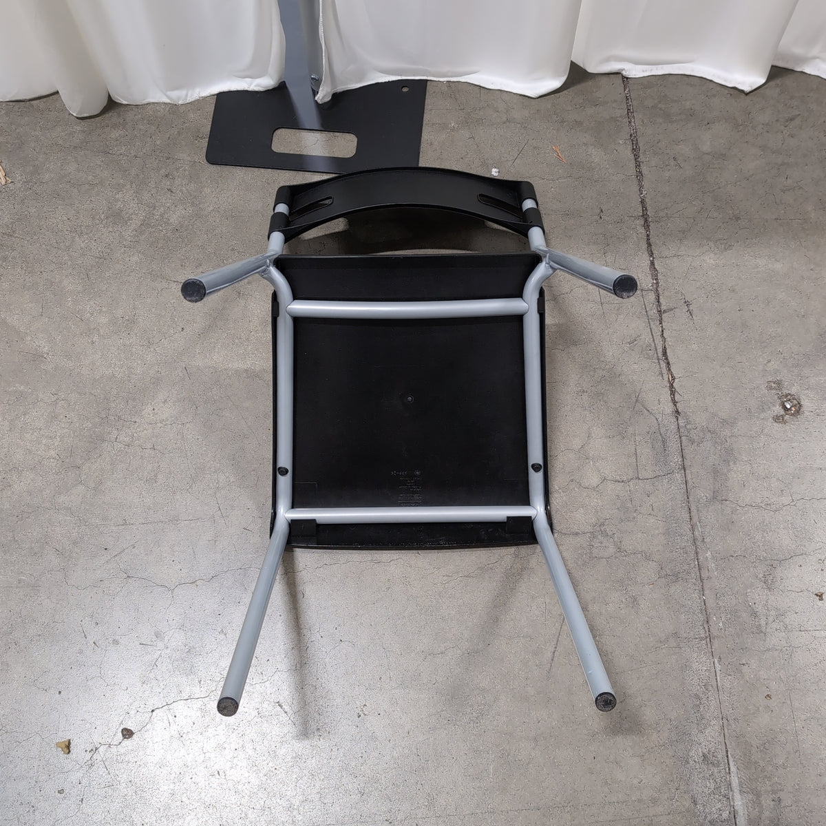 Black Plastic Stackable Chair with Striped Cushion