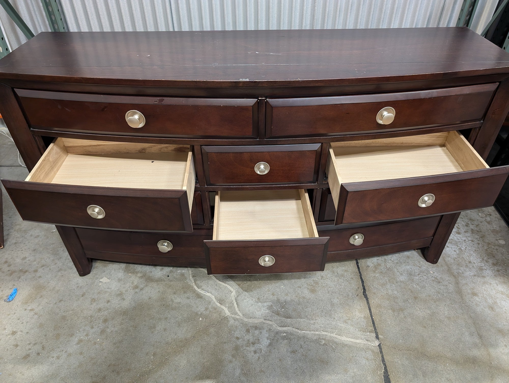 Dark Wood Curved Front Nine-Drawer Dresser