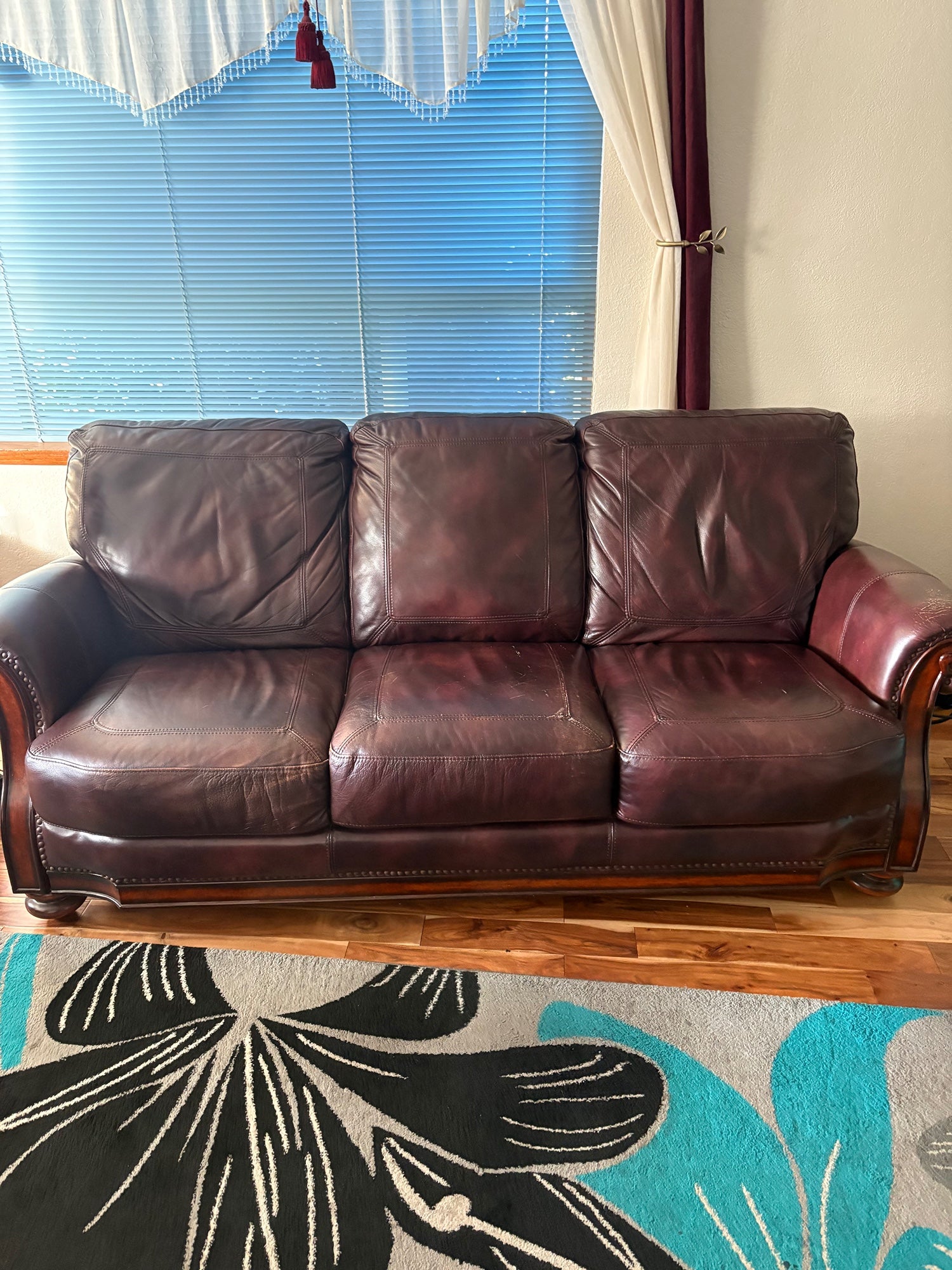 Classic Burgundy Leather Three-Seater Sofa with Rolled Arms