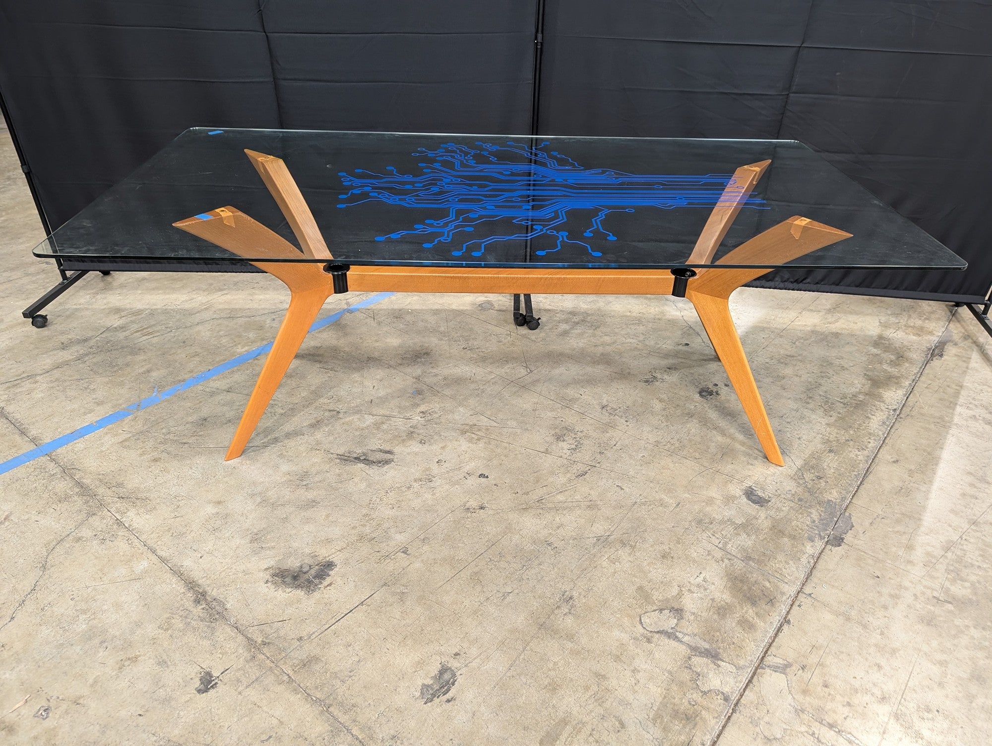 Modern Tech-Inspired Glass Top Dining Table with Splayed Wood Base