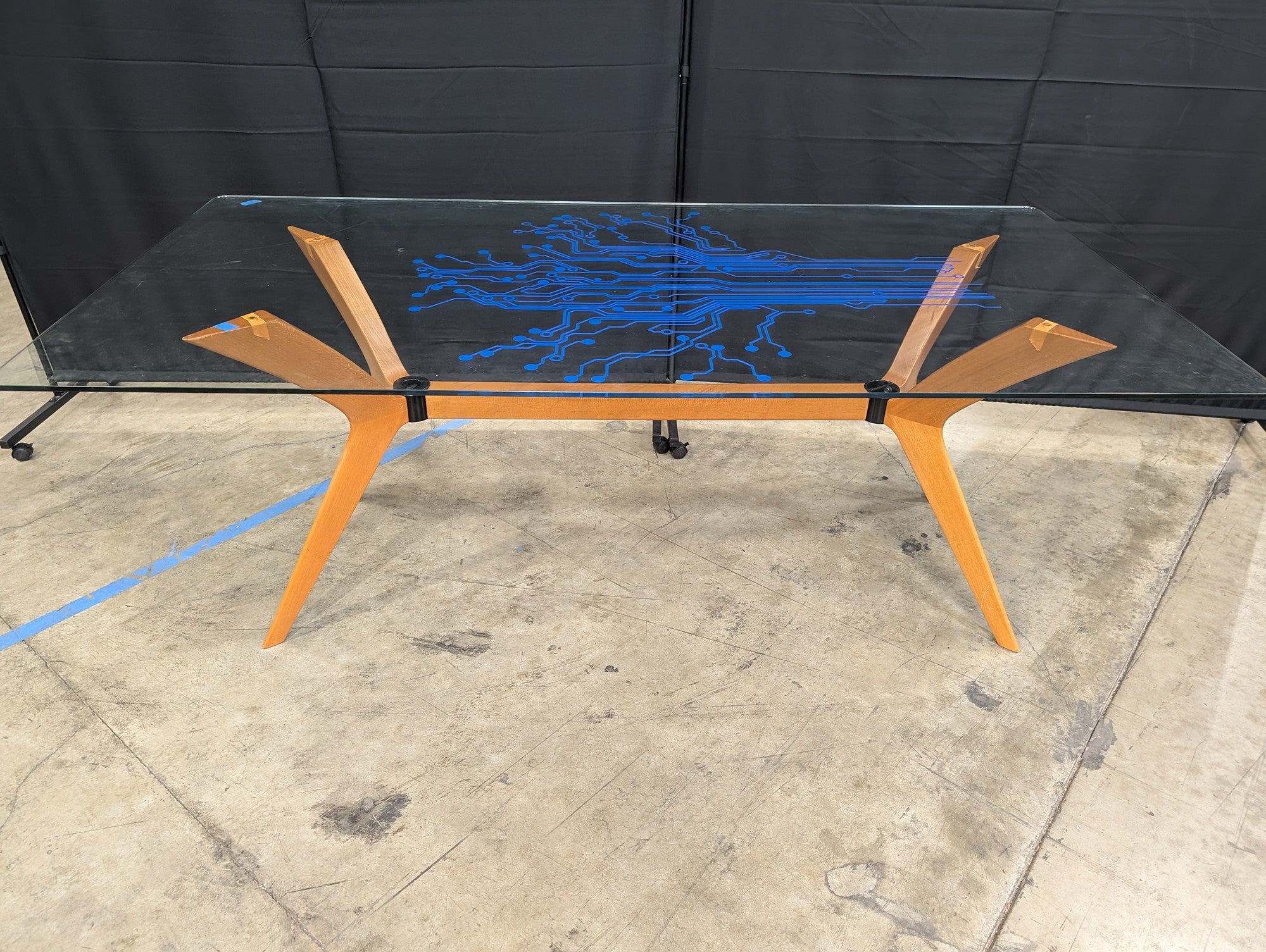 Modern Tech-Inspired Glass Top Dining Table with Splayed Wood Base