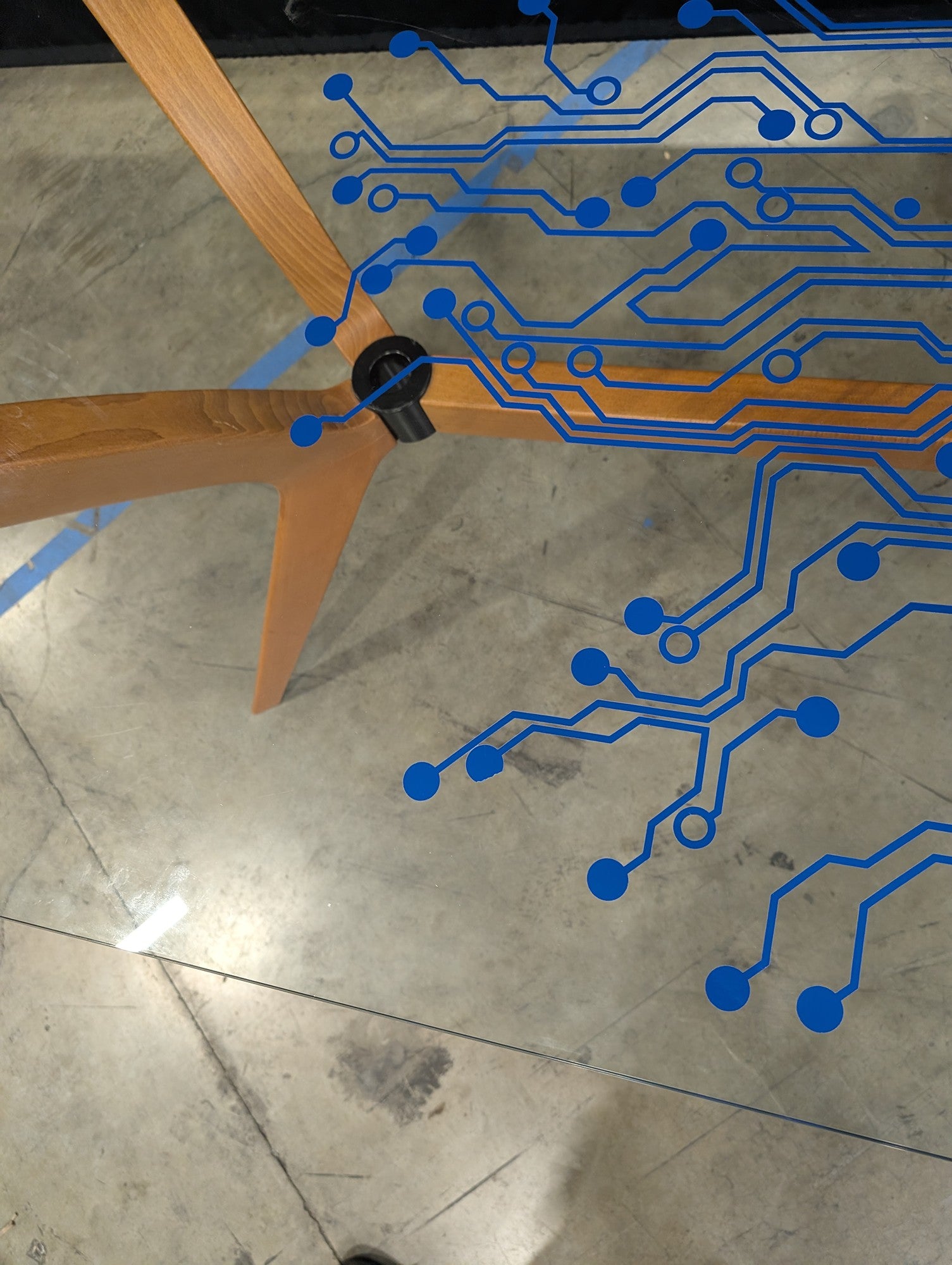 Modern Tech-Inspired Glass Top Dining Table with Splayed Wood Base