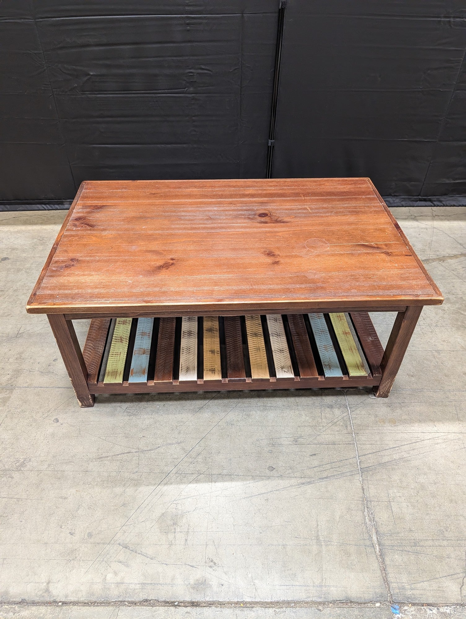 Rustic Wood Coffee Table with Multi-Color Slatted Shelf
