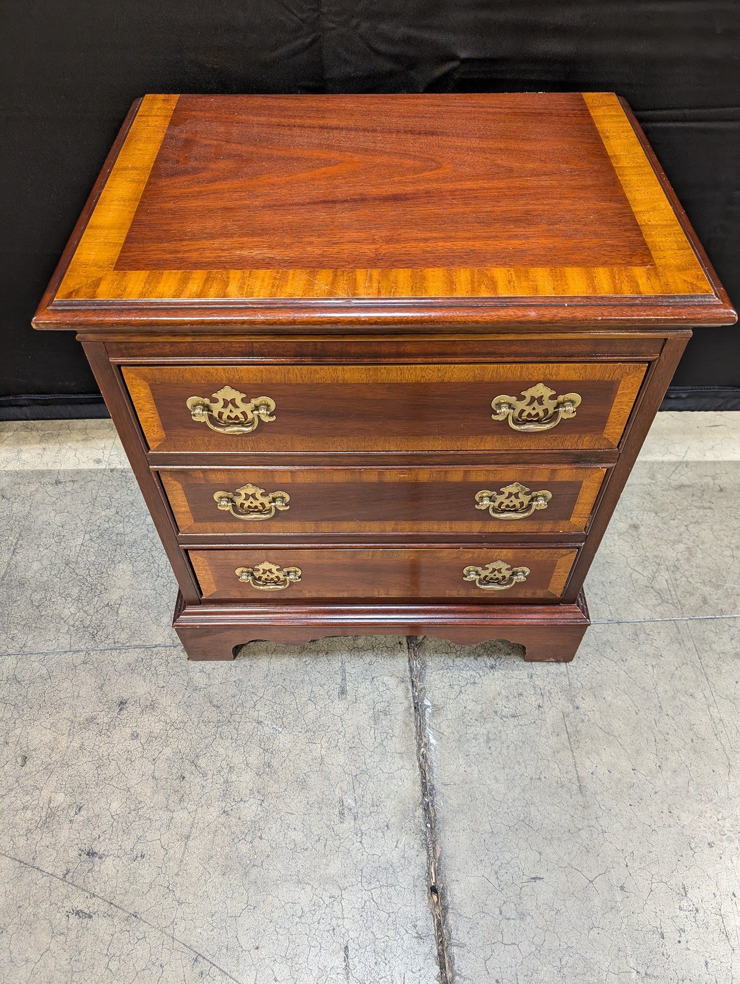 Traditional Dark Wood Three-Drawer Chest with Ornate Brass Pulls