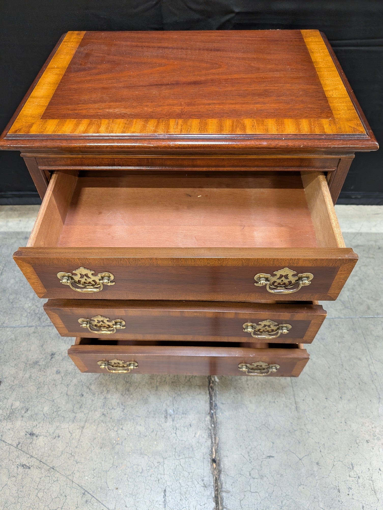 Traditional Dark Wood Three-Drawer Chest with Ornate Brass Pulls