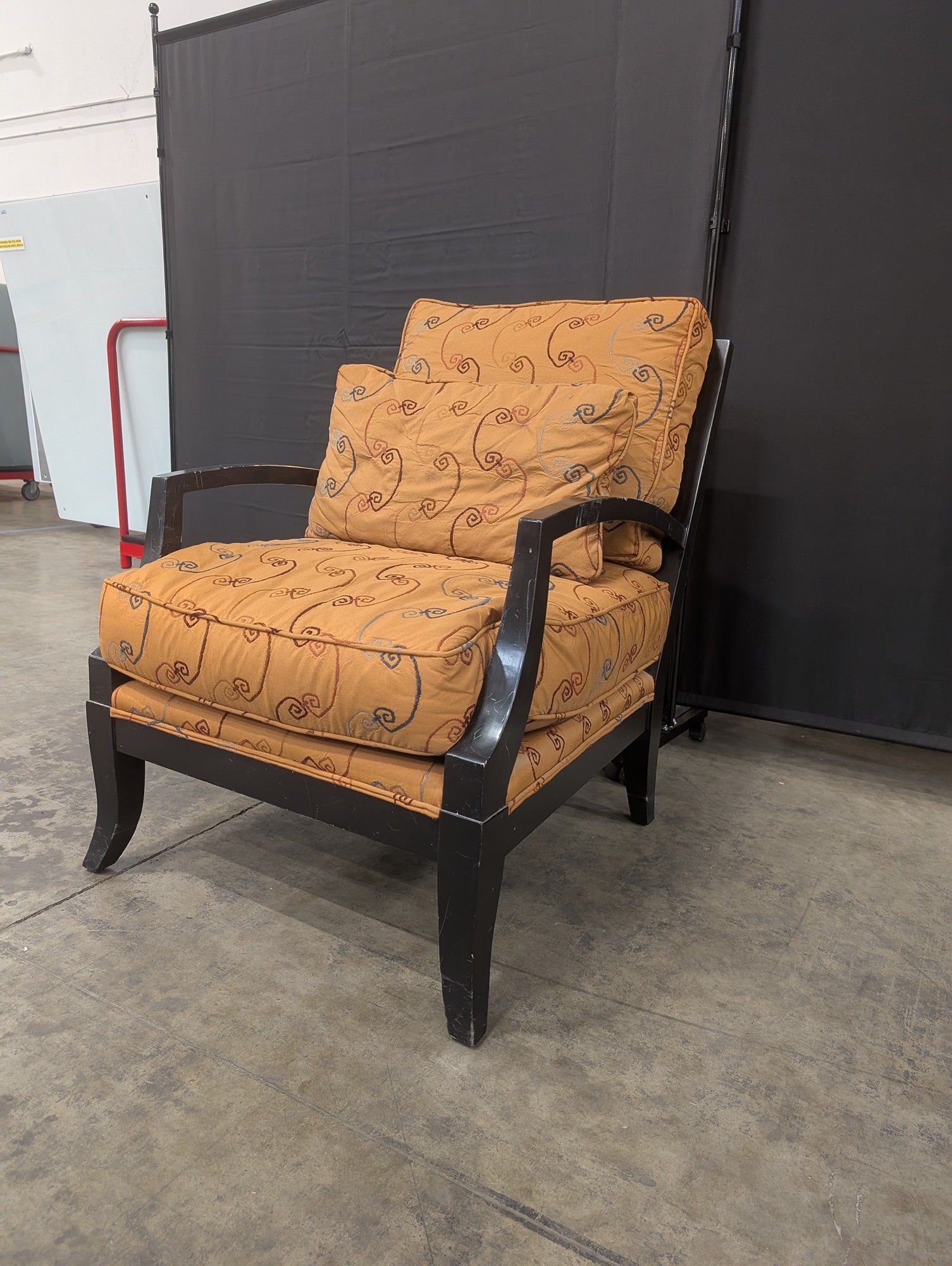 Orange Patterned Upholstered Armchair with Dark Wood Frame