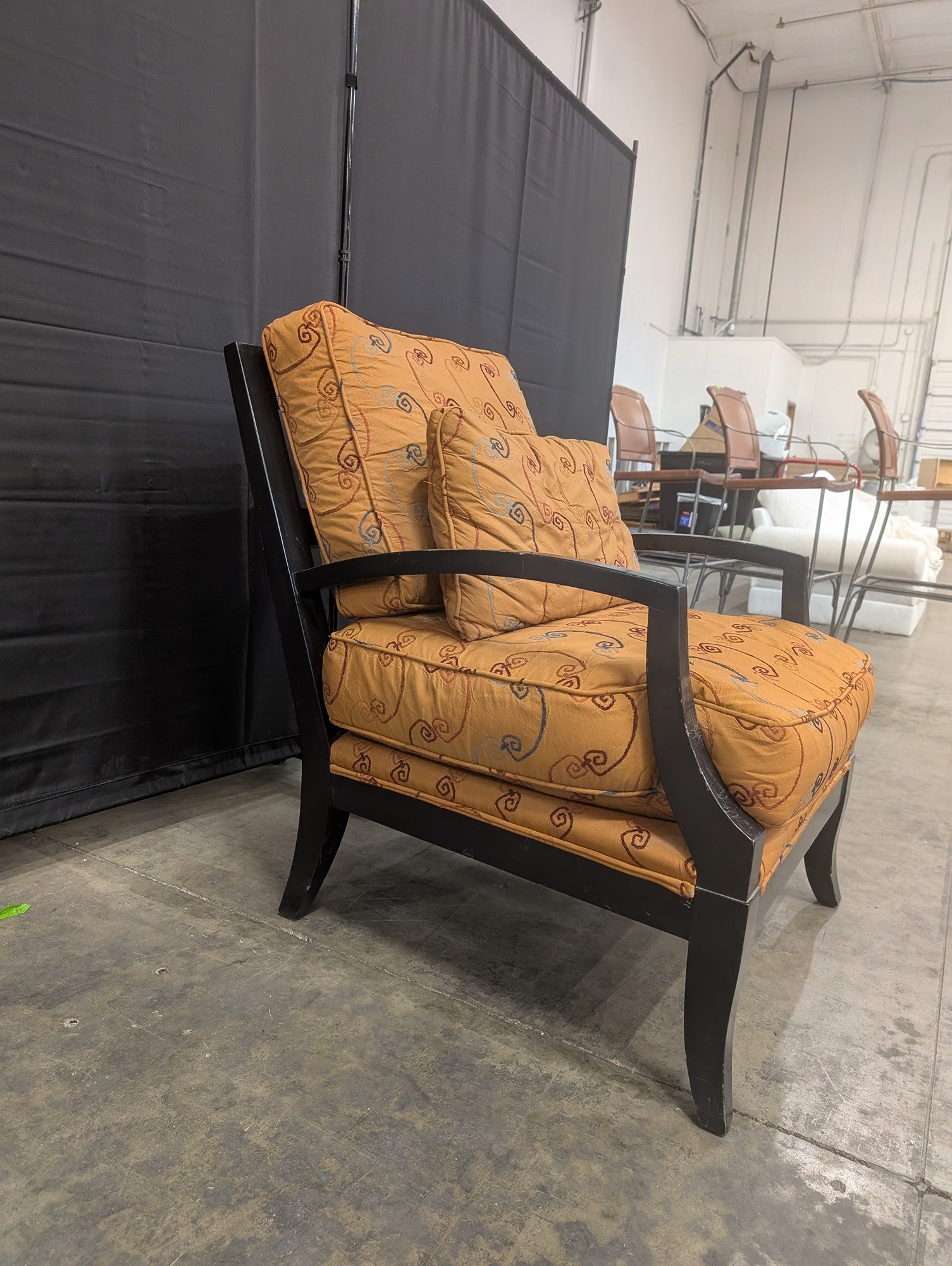 Orange Patterned Upholstered Armchair with Dark Wood Frame