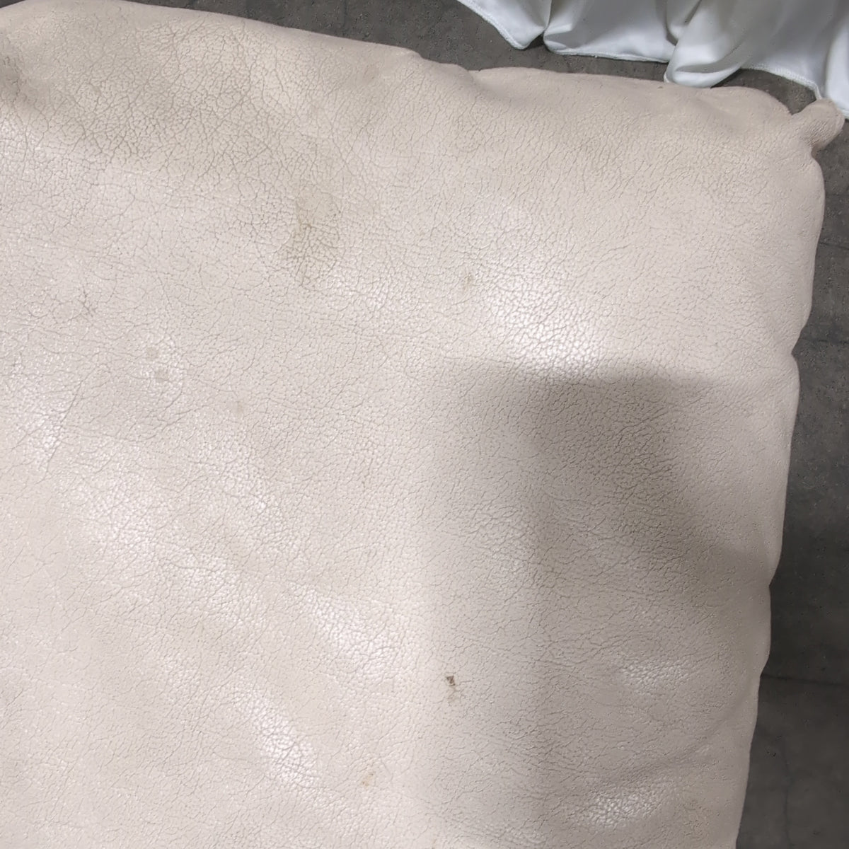 Off-White Faux Leather Ottoman with Top Stitching
