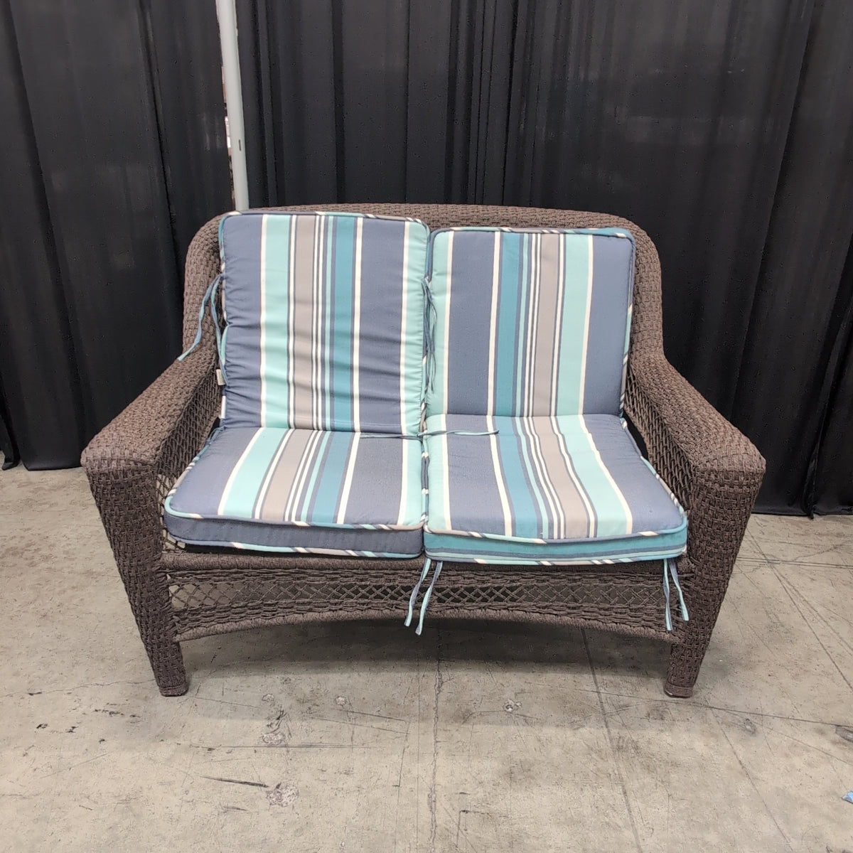 Dark brown wicker loveseat