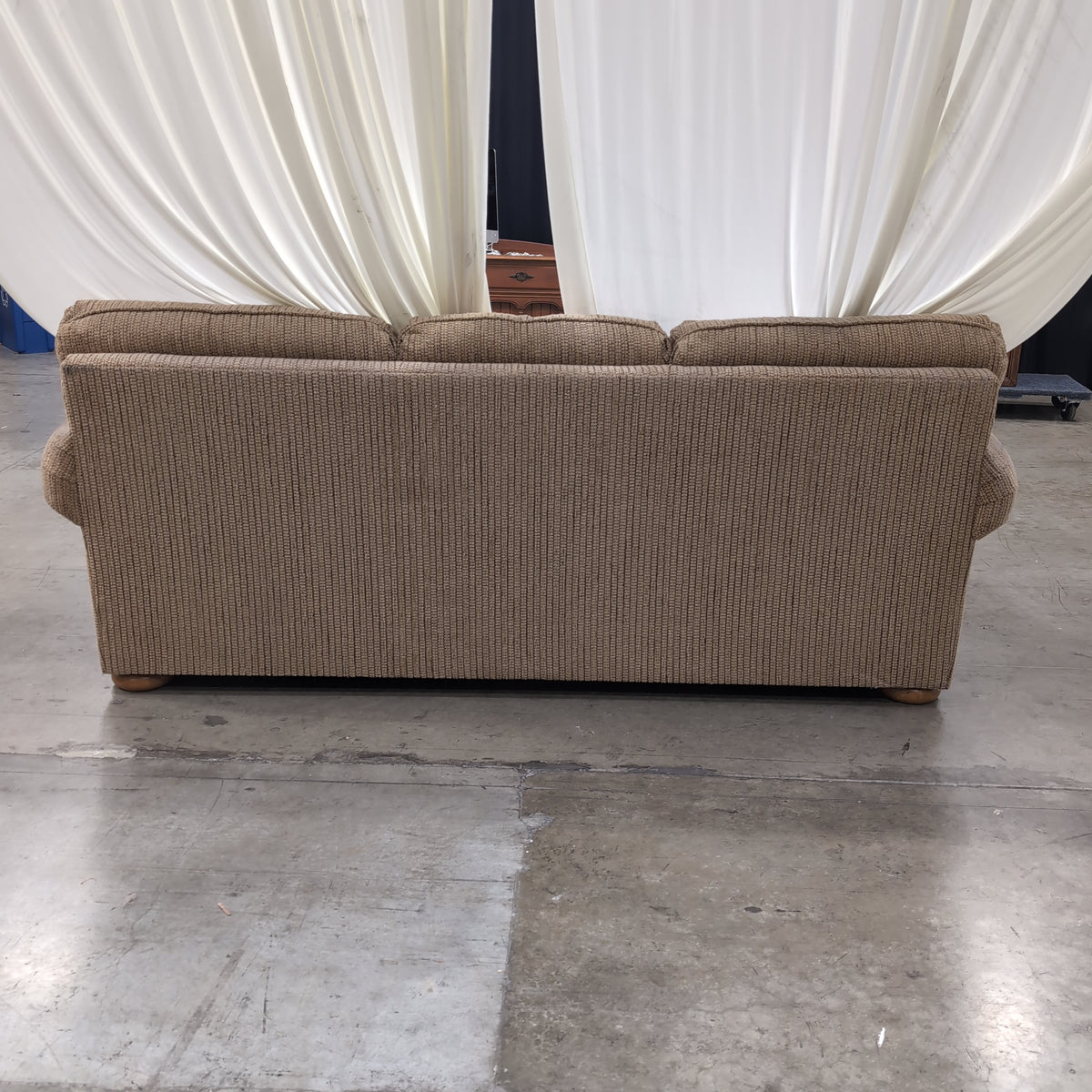 Tan Textured Fabric Three-Cushion Couch with Rolled Arms