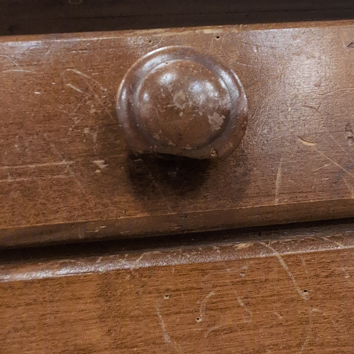 Brown Wood Four-Drawer Desk with Round Knobs