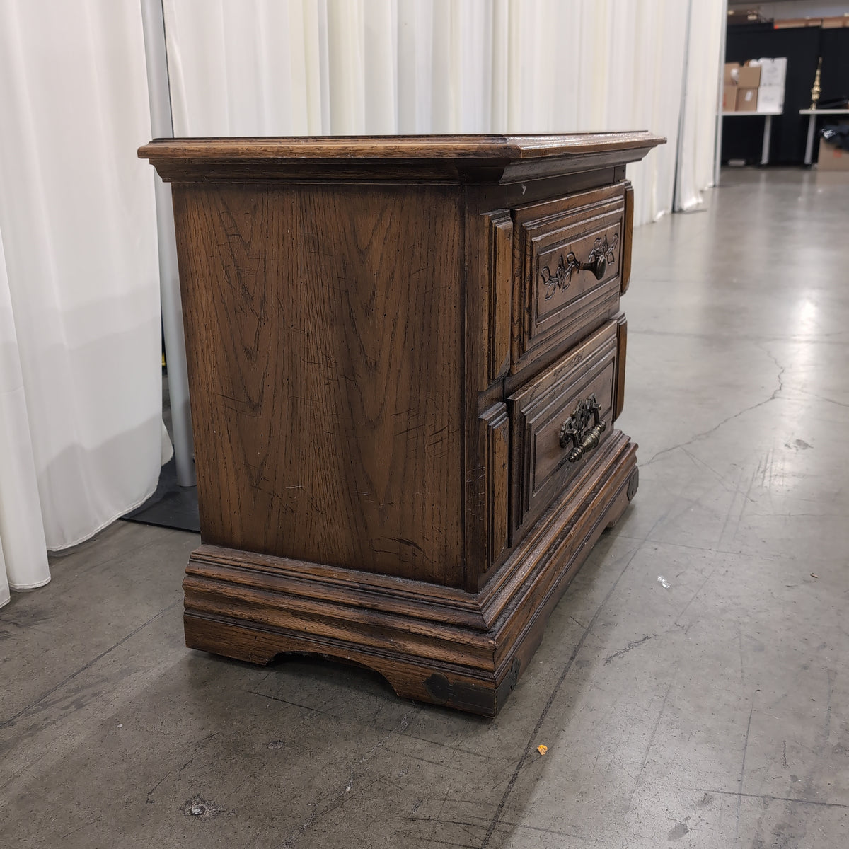 Traditional Dark Wood Two-Drawer Nightstand with Ornate Hardware