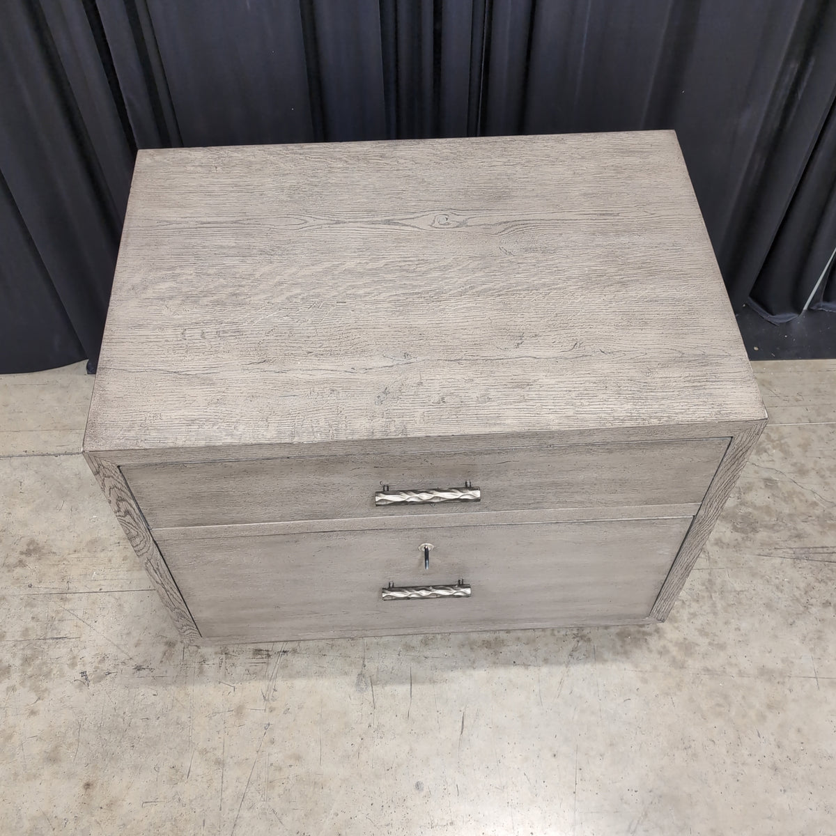 Light Wood Two-Drawer Nightstand with Textured Hardware