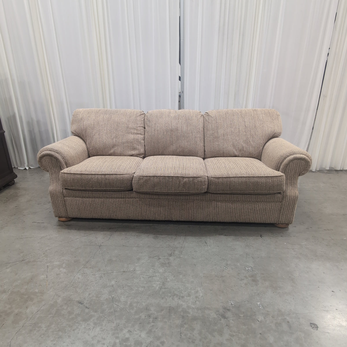 Tan Textured Fabric Three-Cushion Couch with Rolled Arms