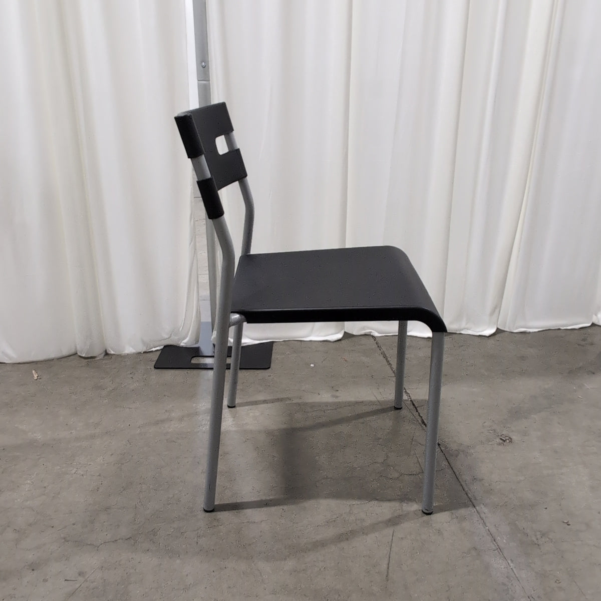 Black Plastic Stackable Chair with Striped Cushion