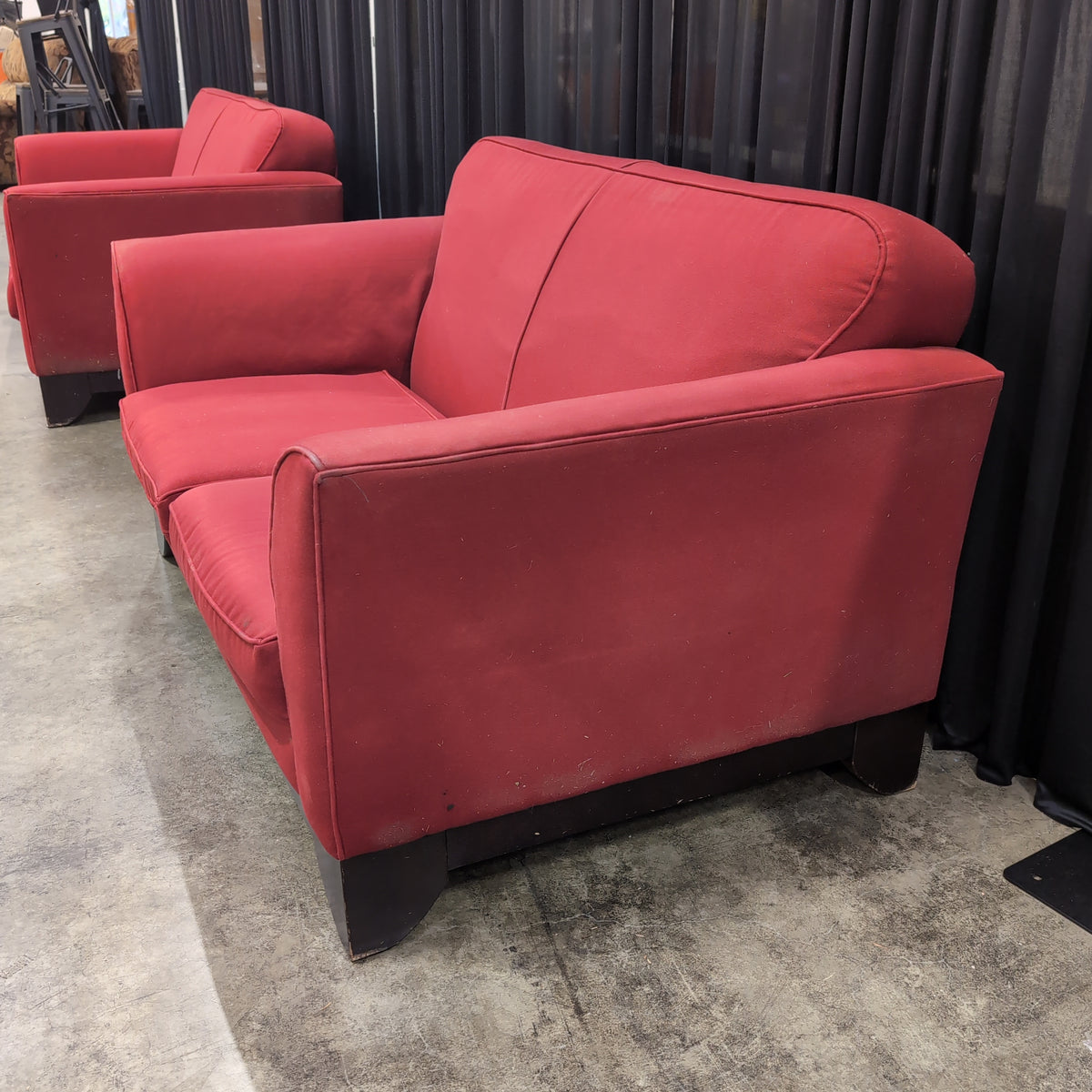 Red Upholstered Two-Cushion Fabric Loveseat with Dark Wood Base