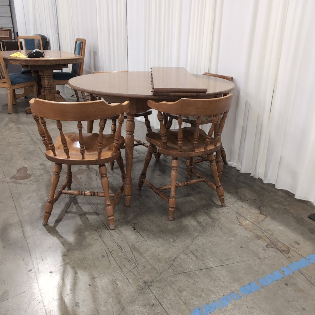 Round Medium Brown Wood Dining Table with Leaf Seam