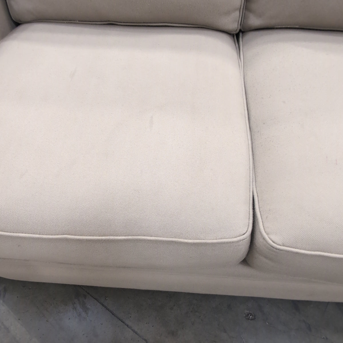 Tan Fabric Three-Cushion Couch with Rolled Arms