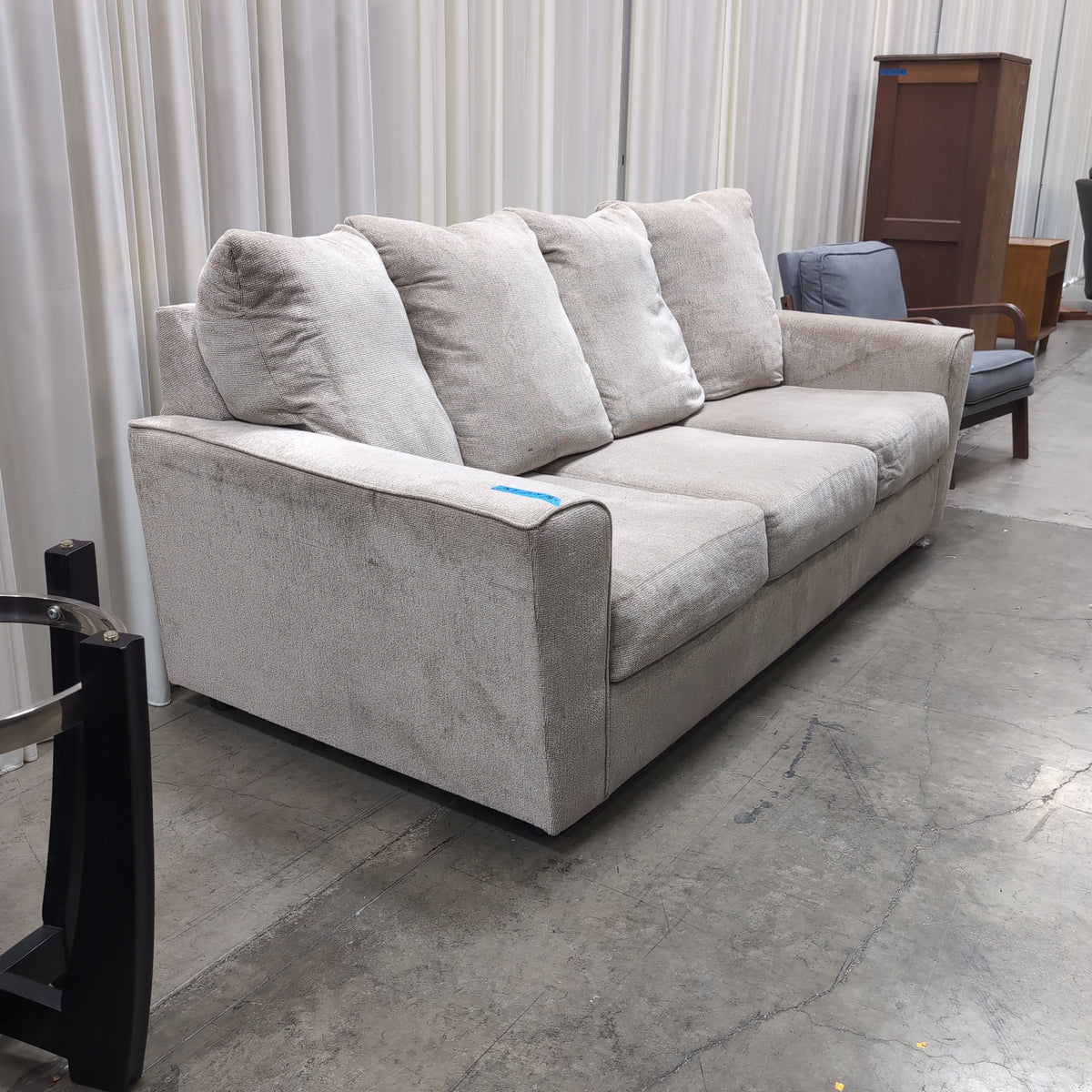 Light Beige Upholstered Three-Seat Couch