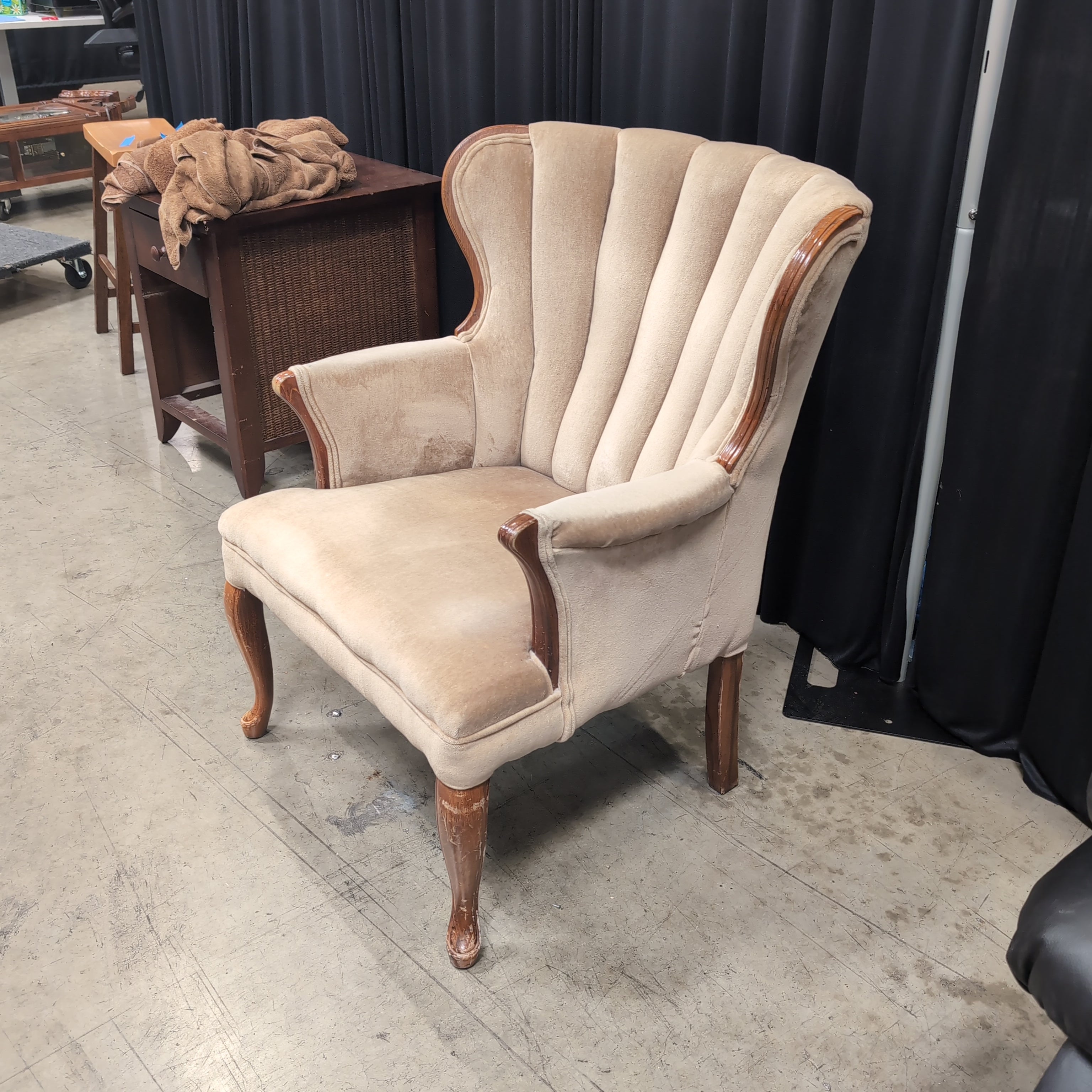 Tan Upholstered Shell Back Armchair with Carved Wood