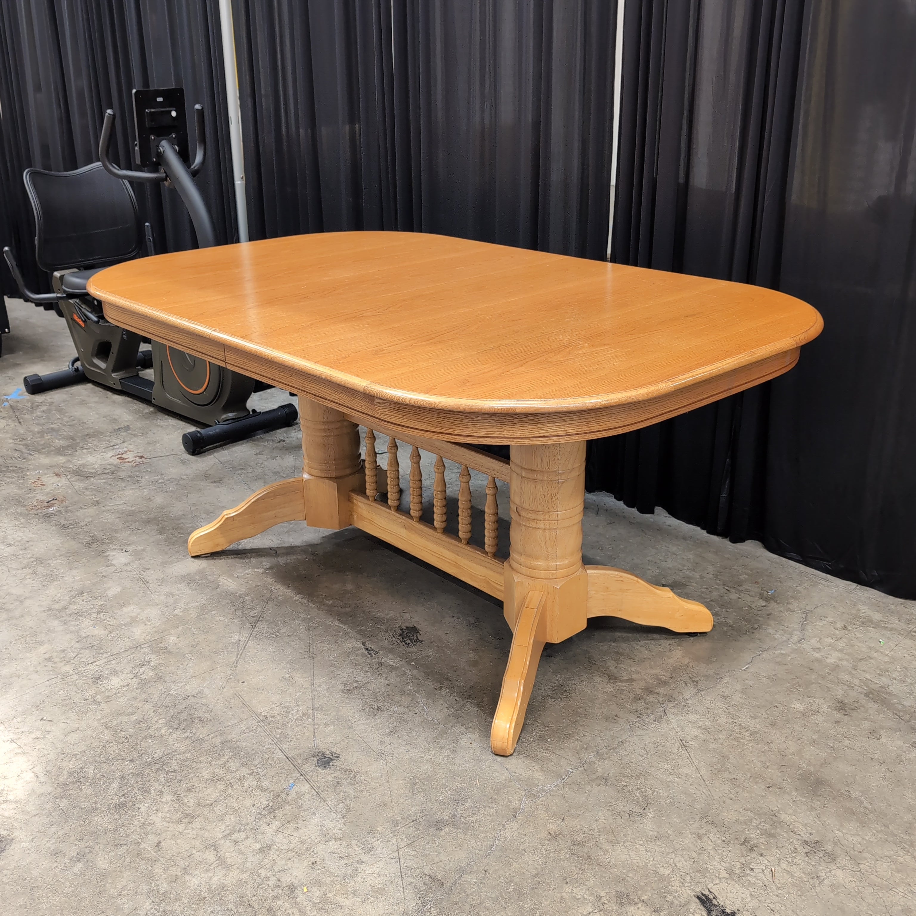 Light Wood Oval Top Dining Table with Spindle Back Chairs