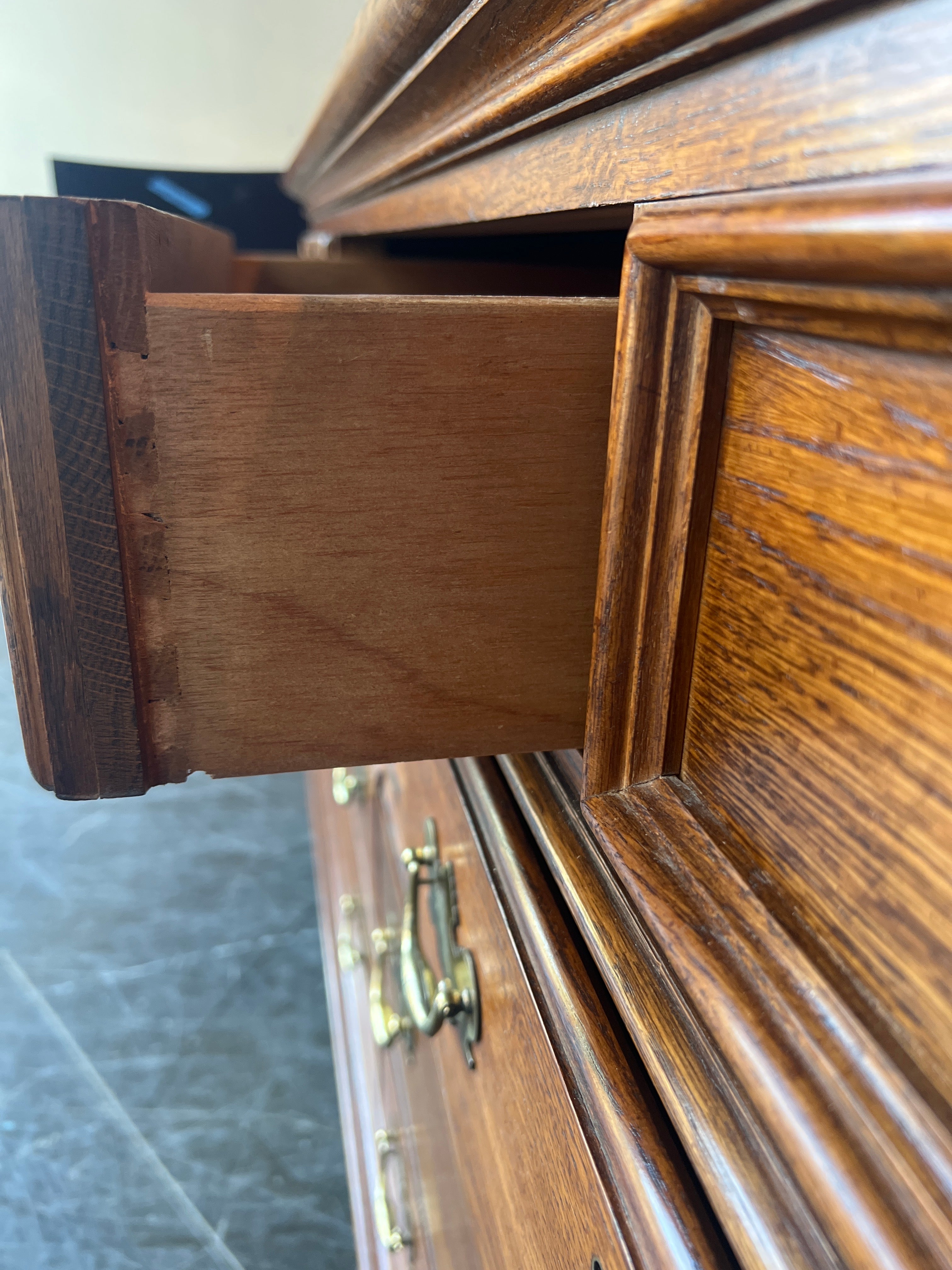 Richly-Toned Wood Dresser with Carved Center Drawer