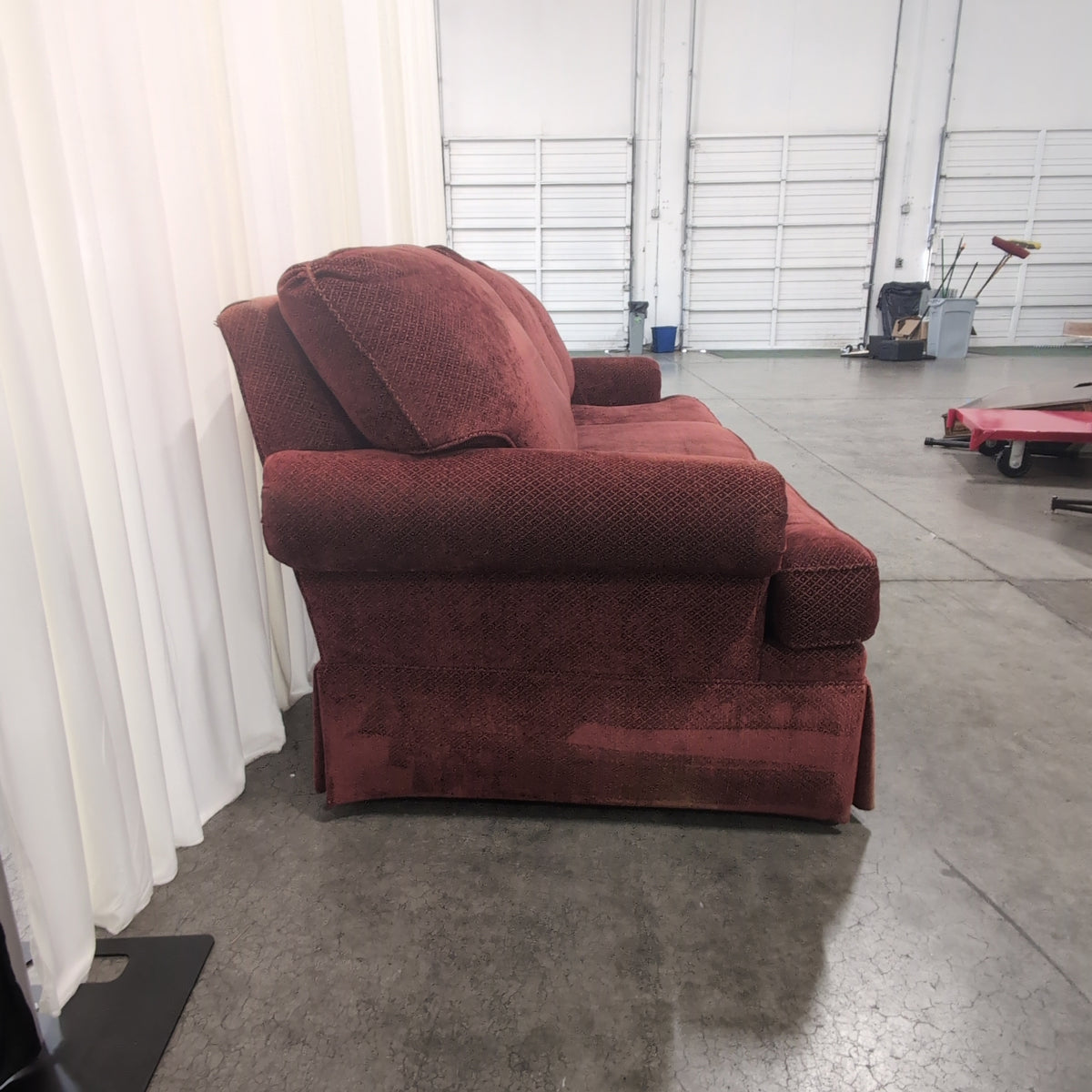 Deep Red Upholstered Three-Seat Couch