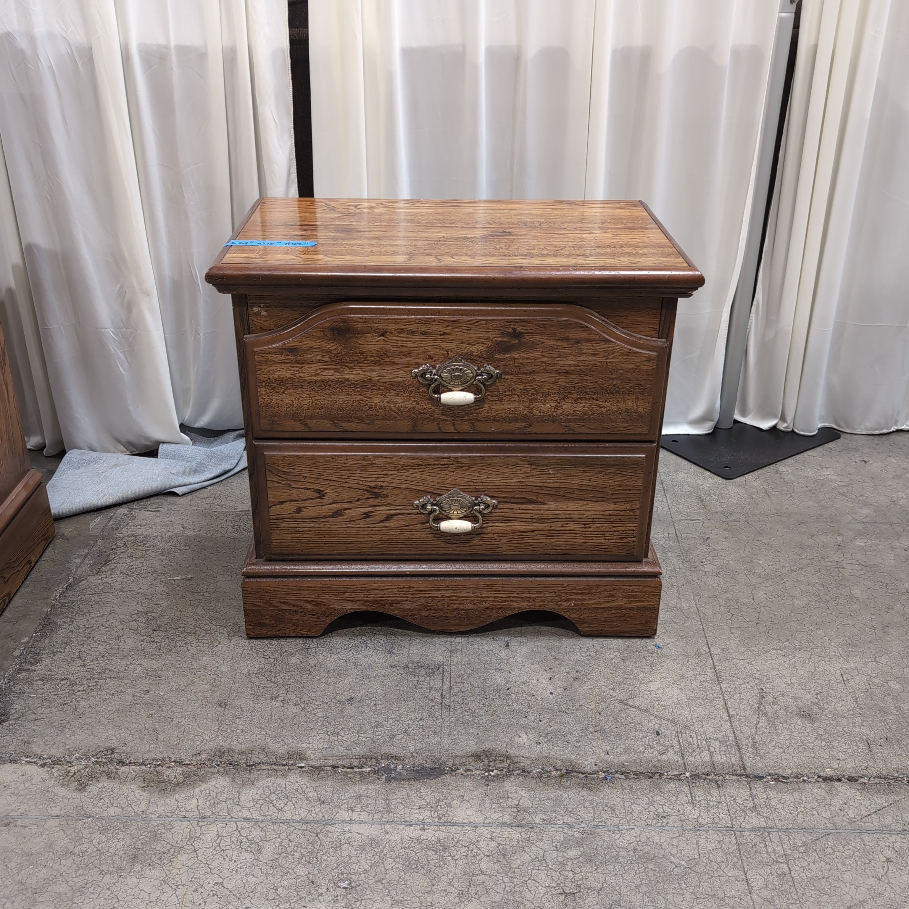 Brown Two-Drawer Wood Nightstand with Ornate Pulls