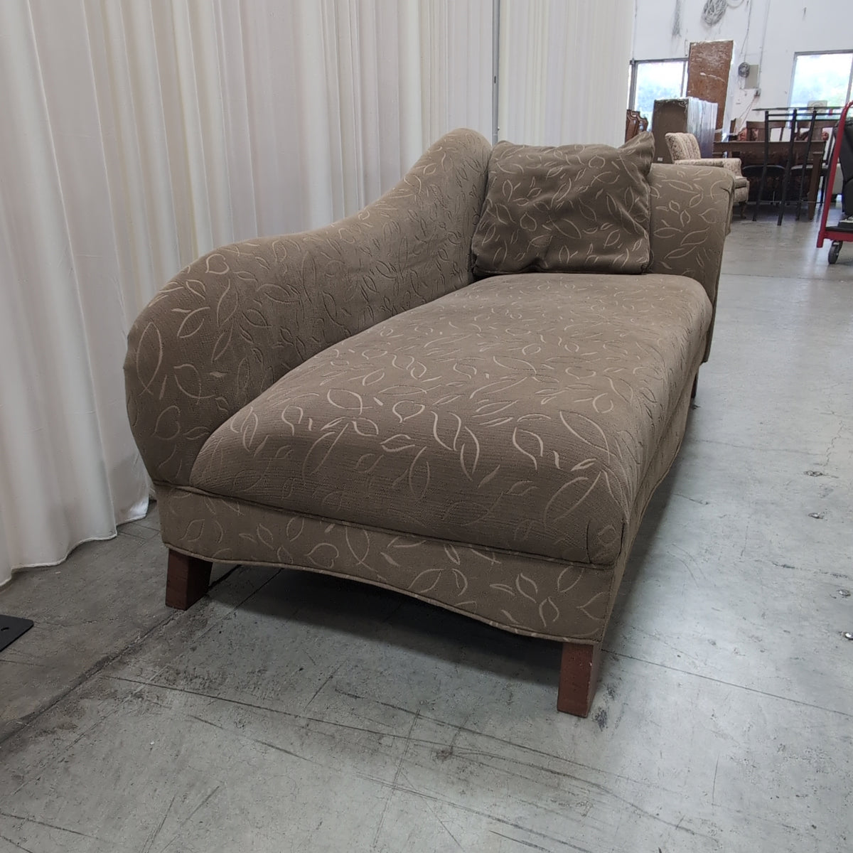 Tan Upholstered Chaise Lounge with Leaf Pattern