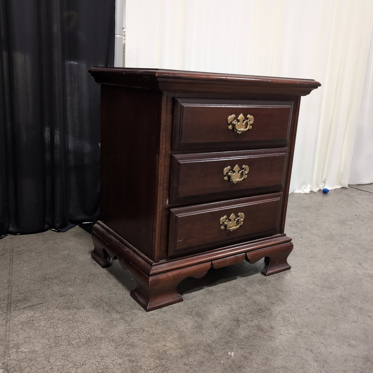Dark Cherry Wood Nightstand with Ornate Hardware