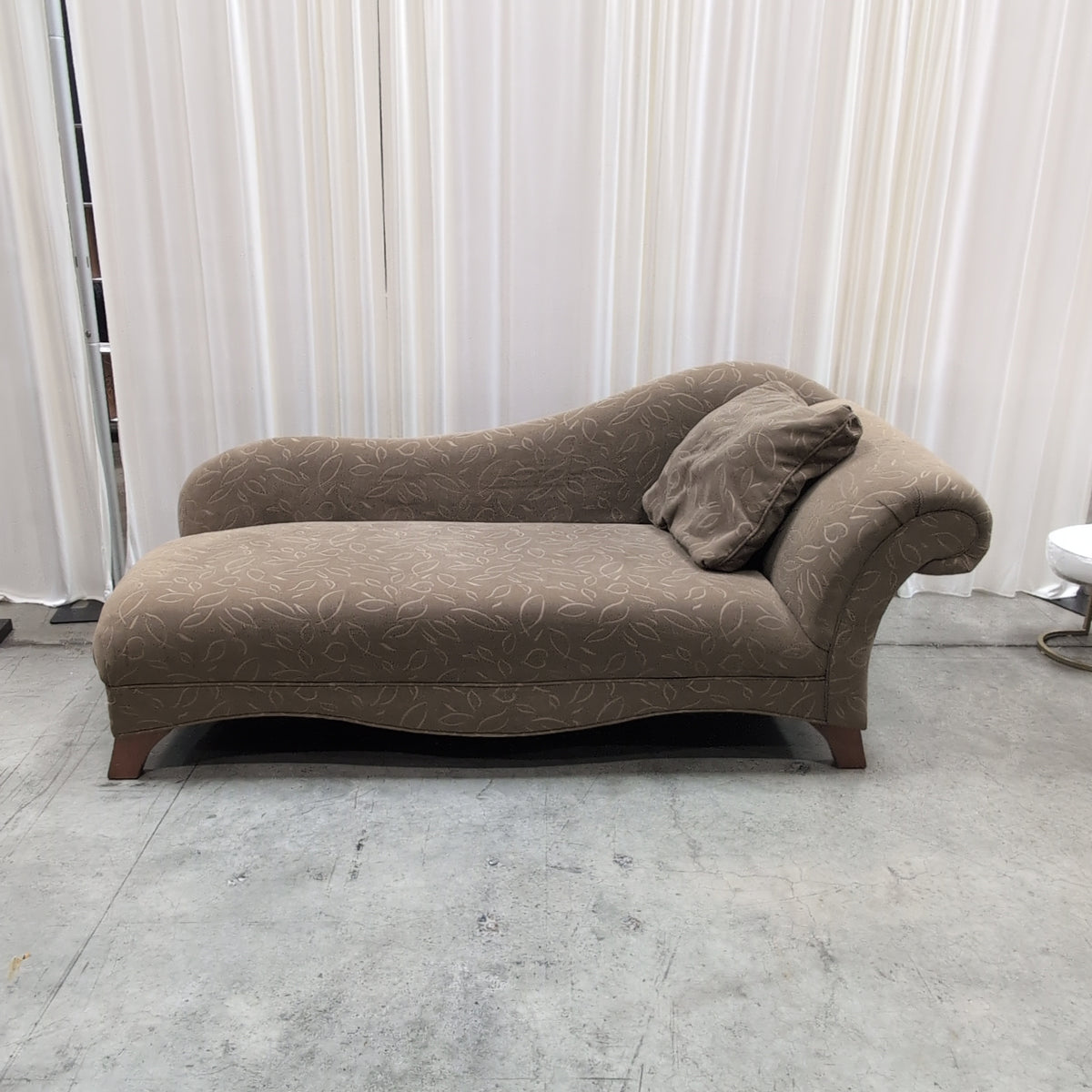 Tan Upholstered Chaise Lounge with Leaf Pattern