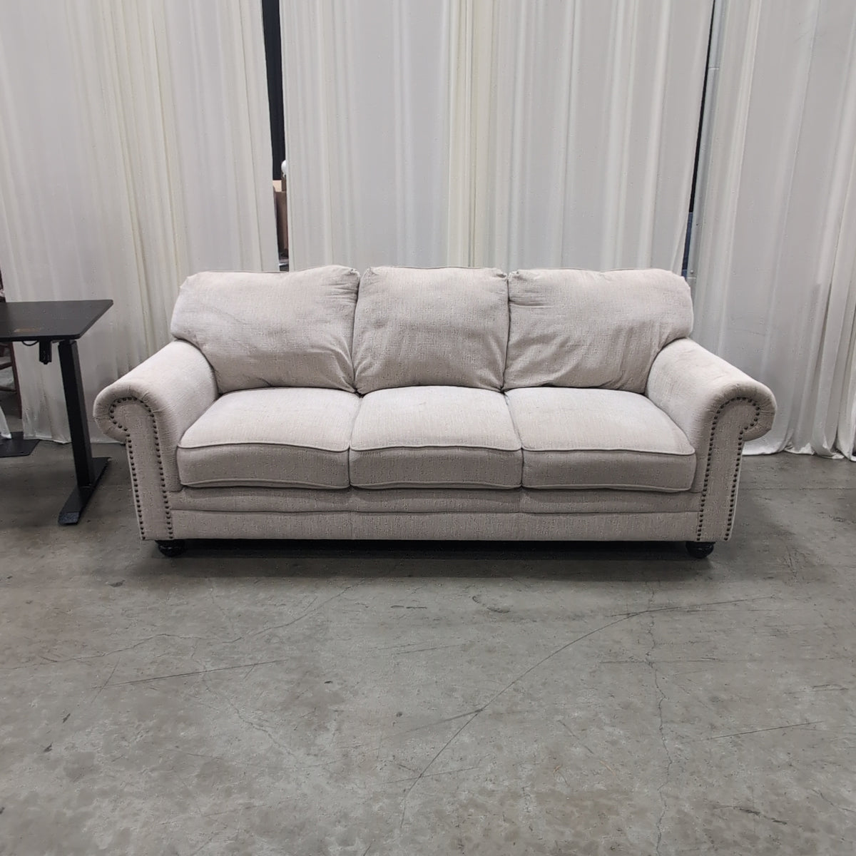 Light Beige Rolled Arm Couch with Nailhead Trim