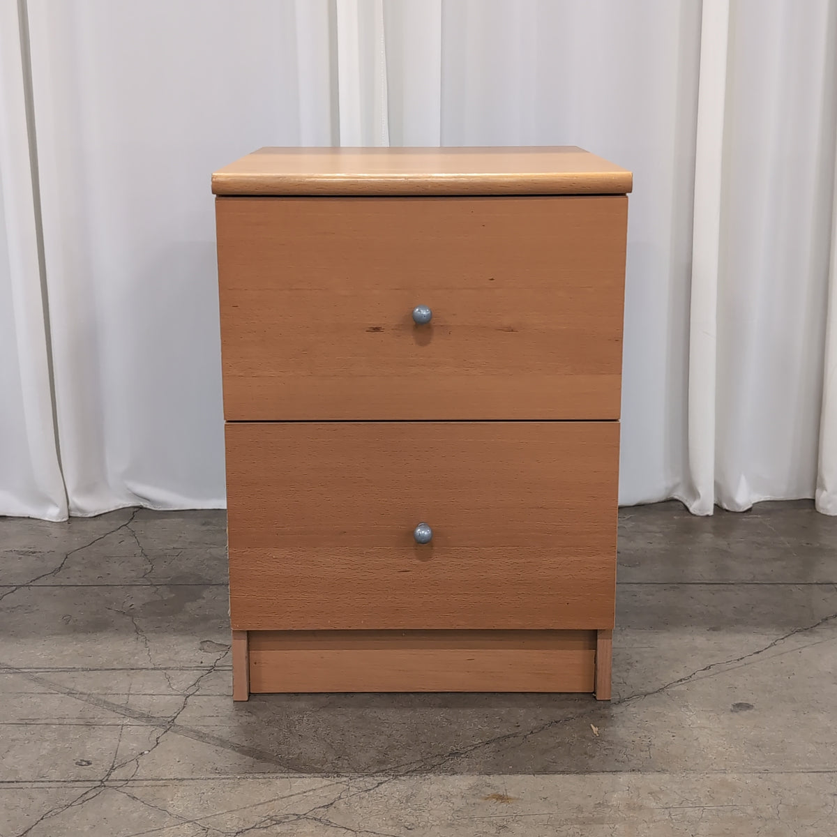 Light Wood Two-Drawer Nightstand with Silver Knobs