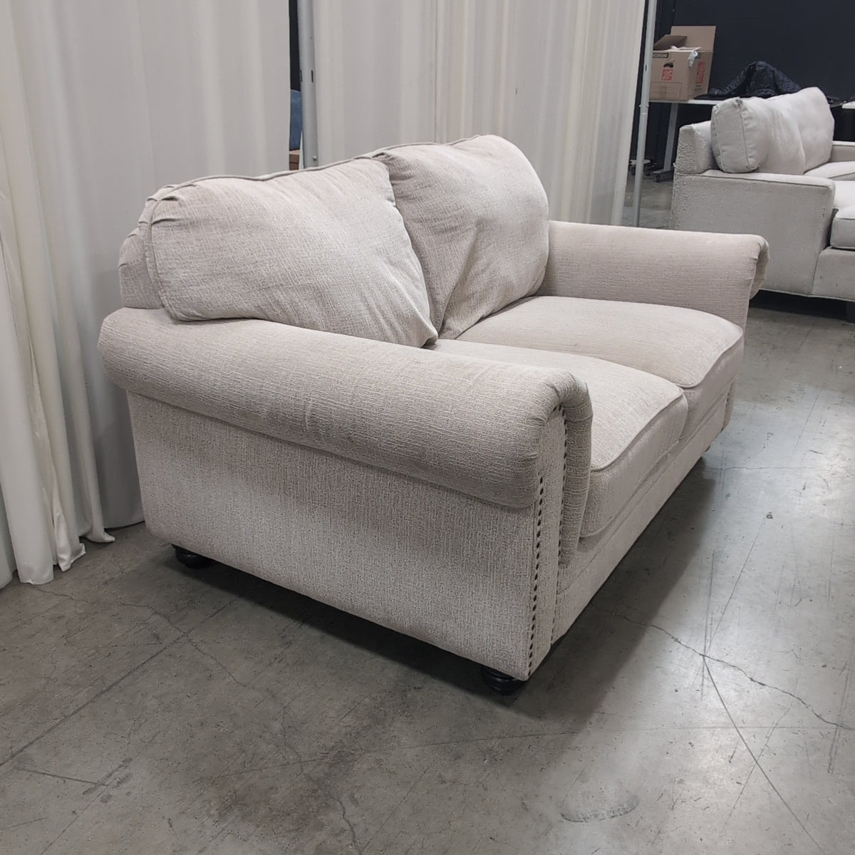 Textured Beige Fabric Loveseat with Nailhead Trim