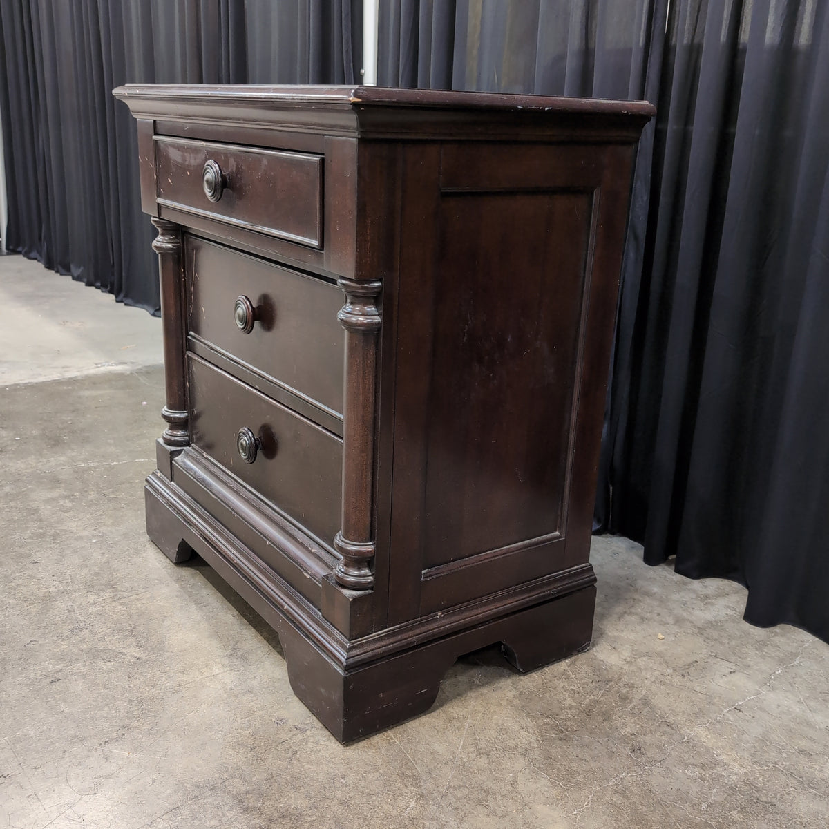 Dark Hardwood Three-Drawer Nightstand with Turned Columns