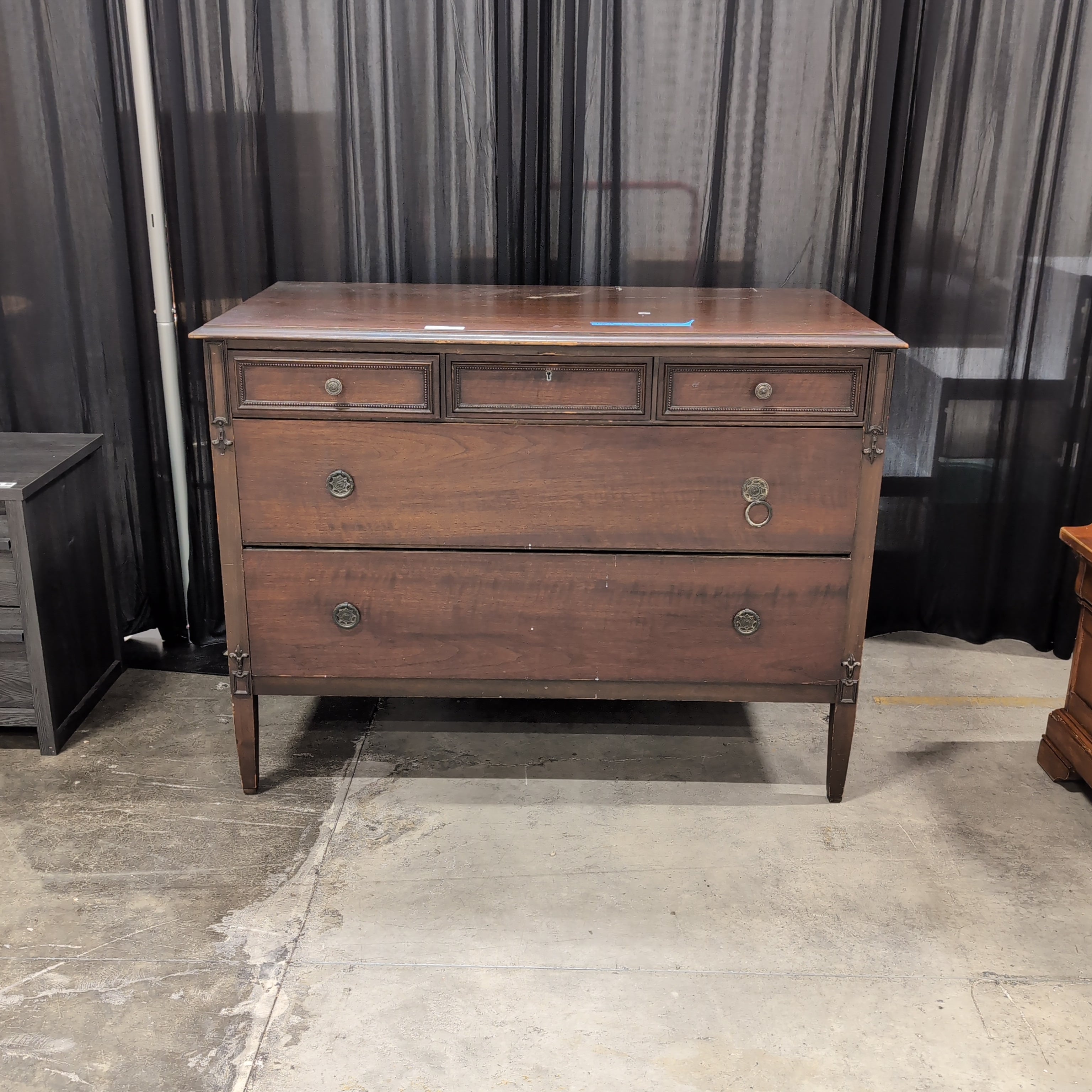 Dark Wood Three-Drawer Dresser with Recessed Panels
