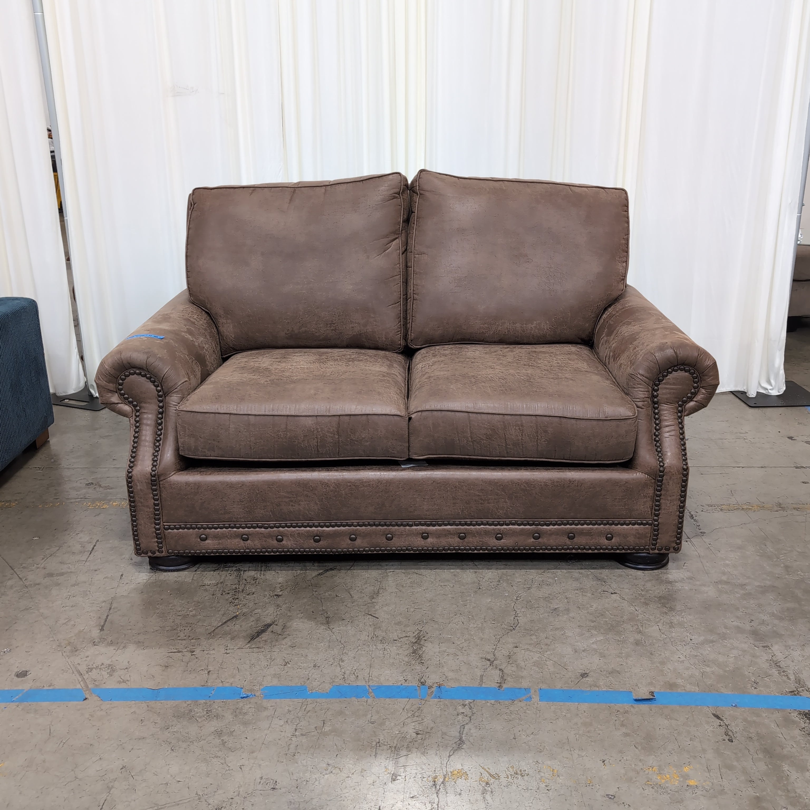 Tan Faux Leather Rolled Arm Loveseat with Nailhead Trim