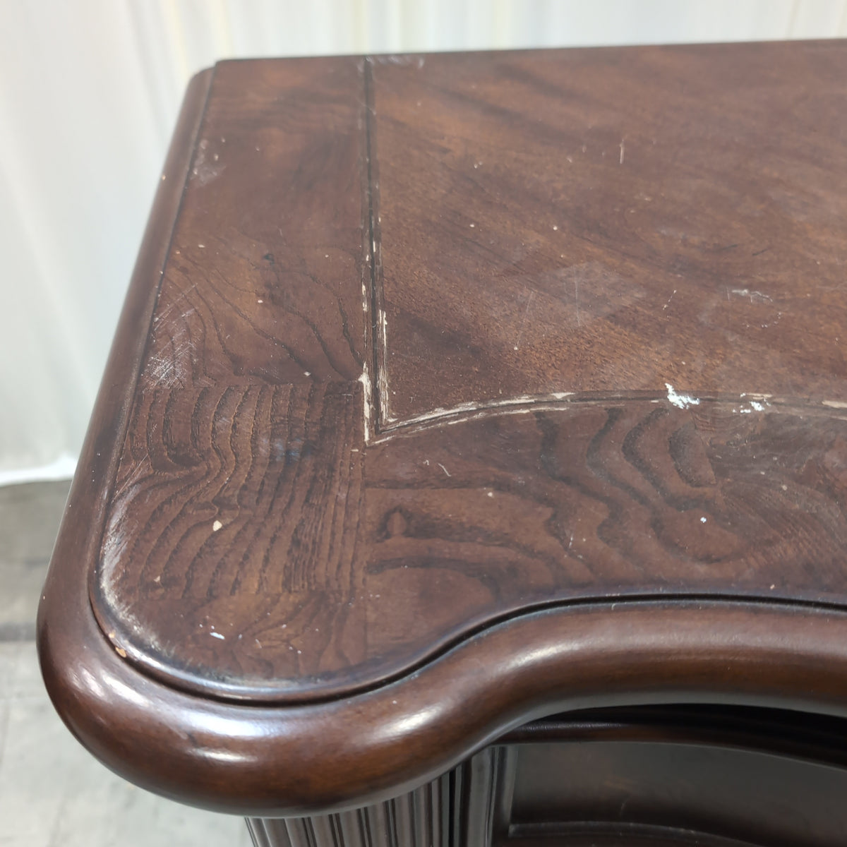 Dark Wood Three-Drawer Nightstand with Ornate Hardware