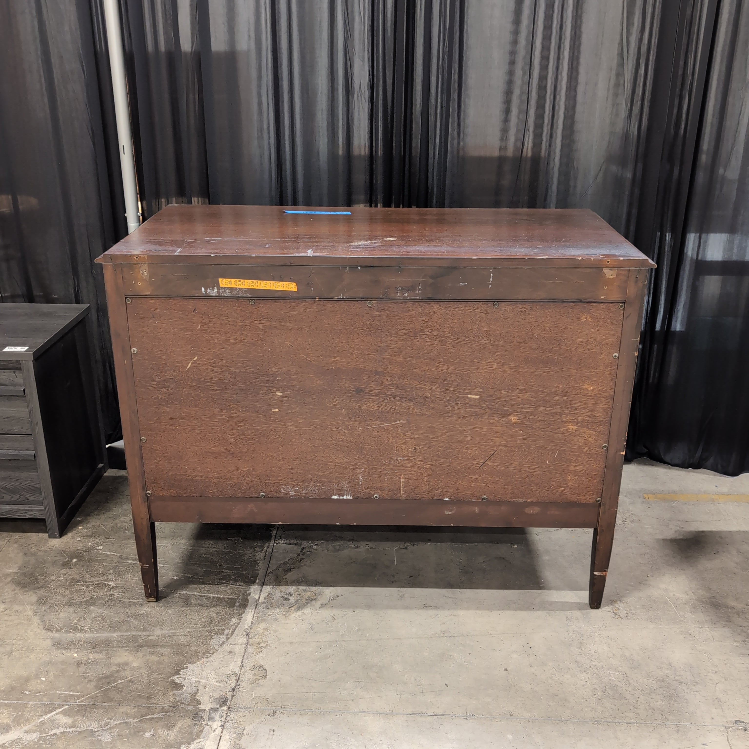 Dark Wood Three-Drawer Dresser with Recessed Panels