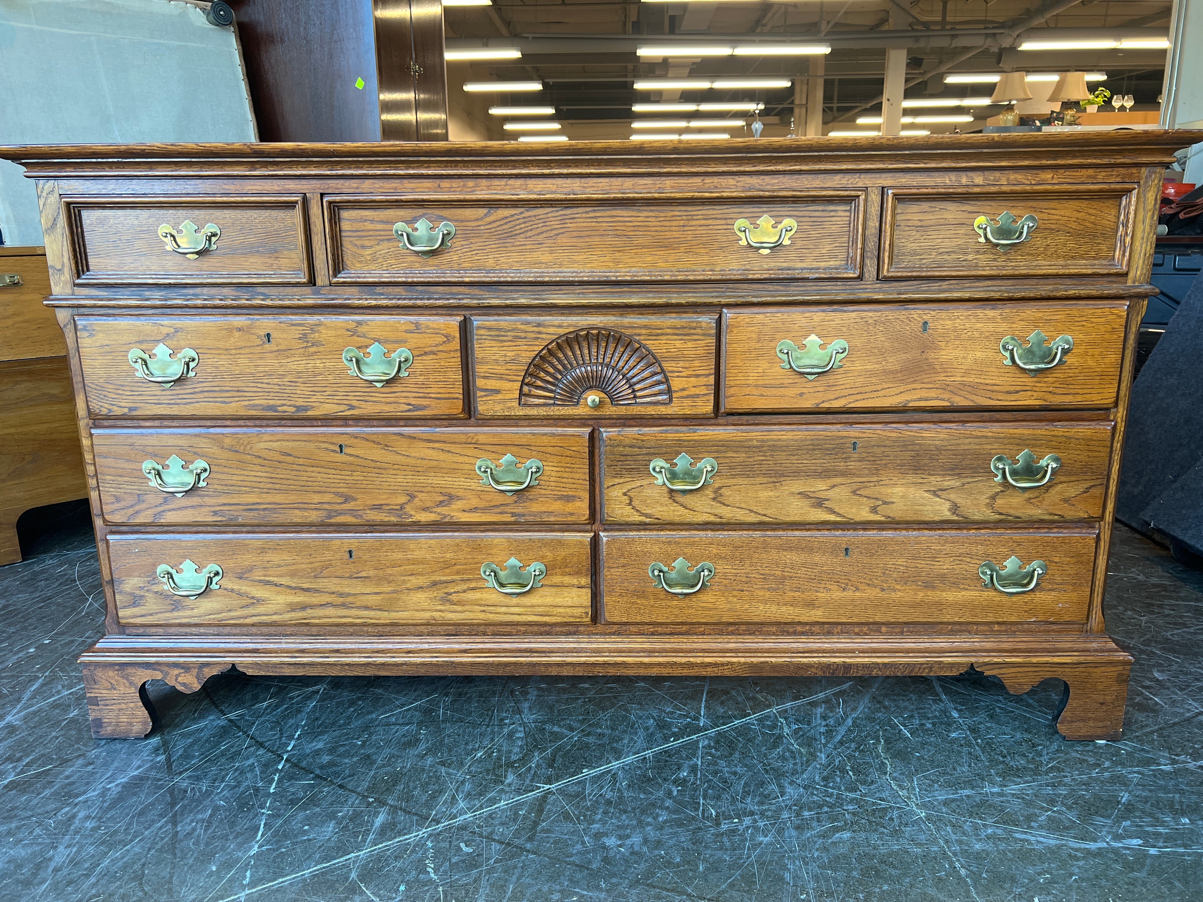 Richly-Toned Wood Dresser with Carved Center Drawer