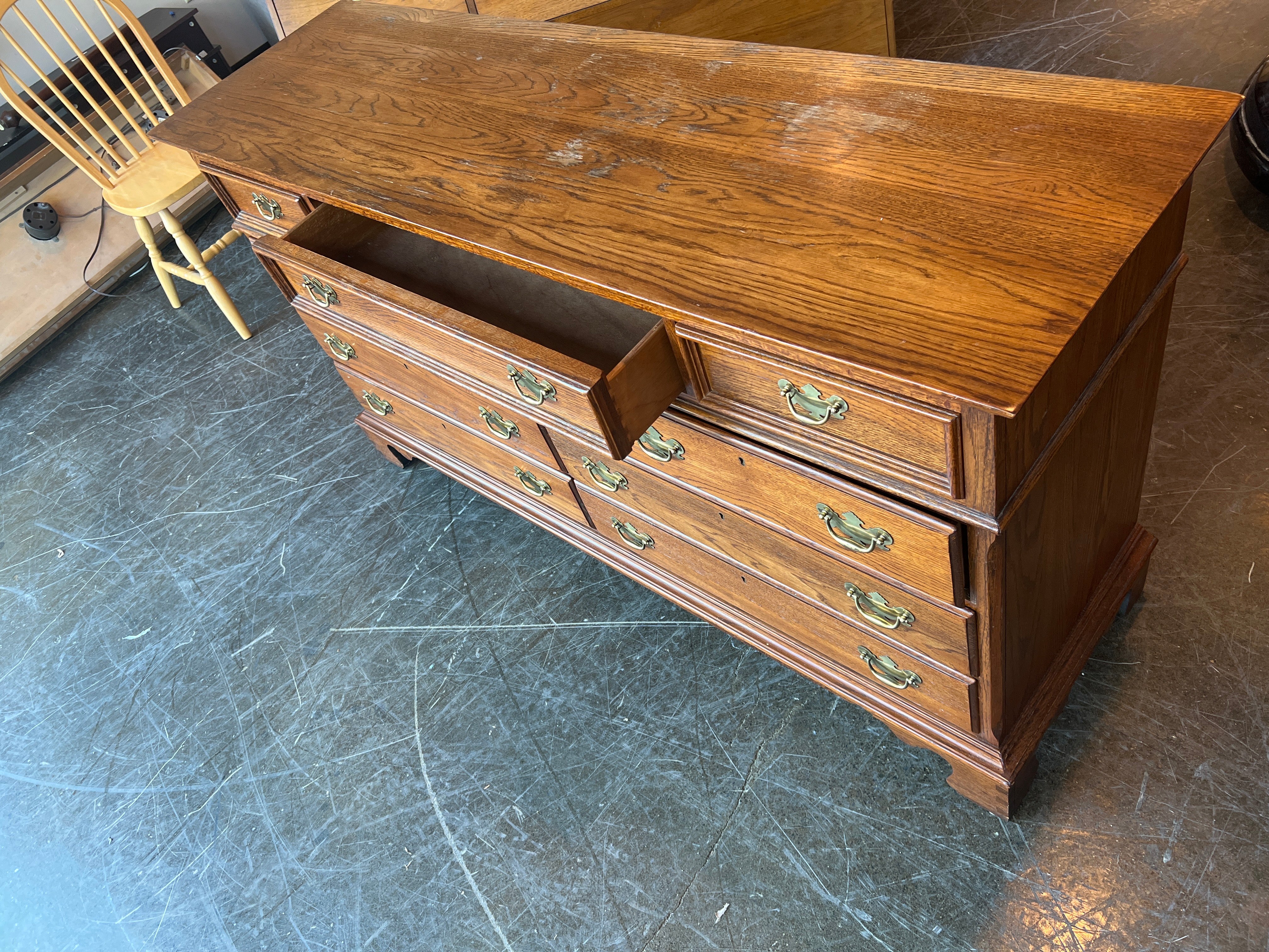 Richly-Toned Wood Dresser with Carved Center Drawer