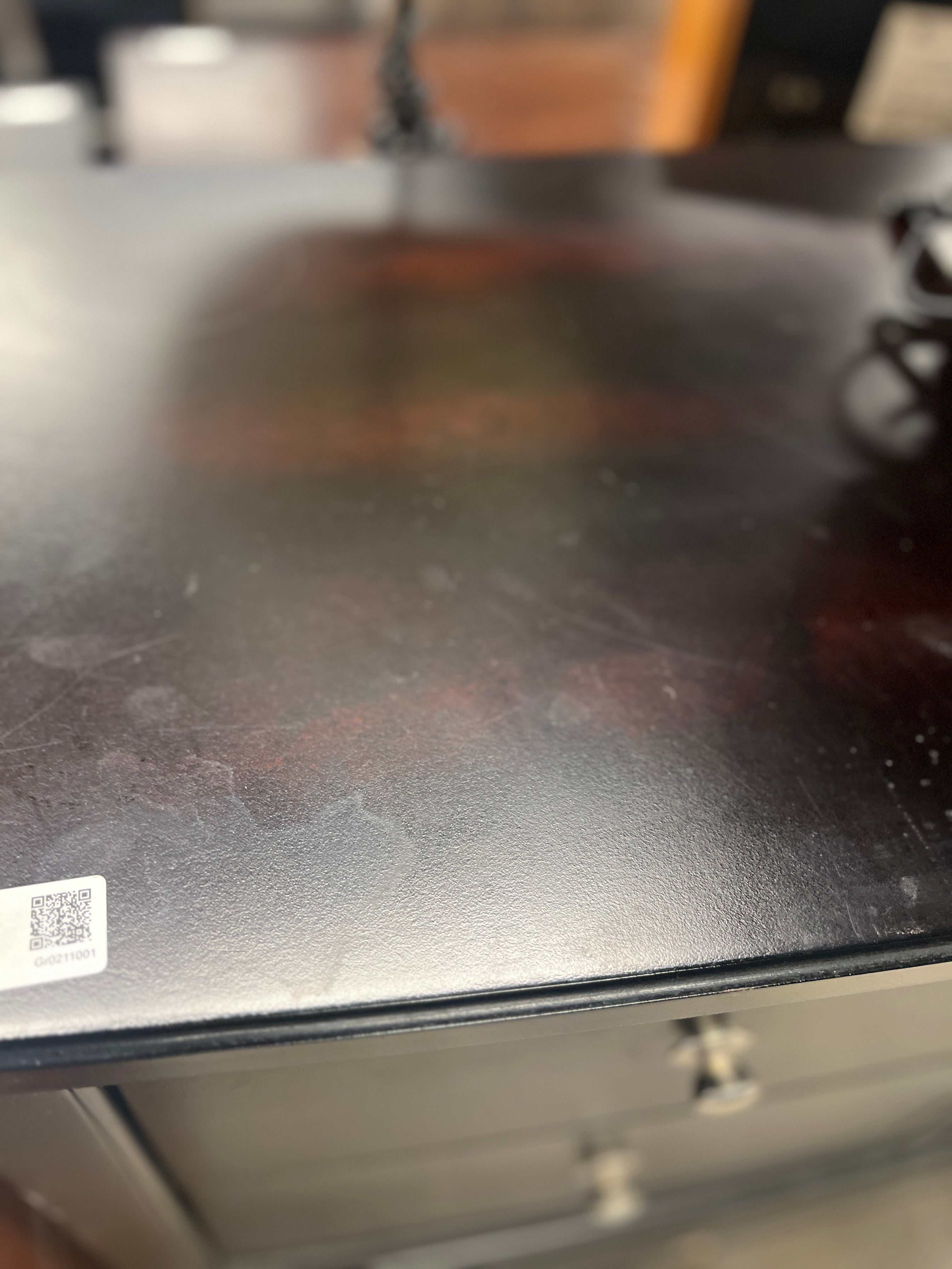 Curved black dresser with silver knobs