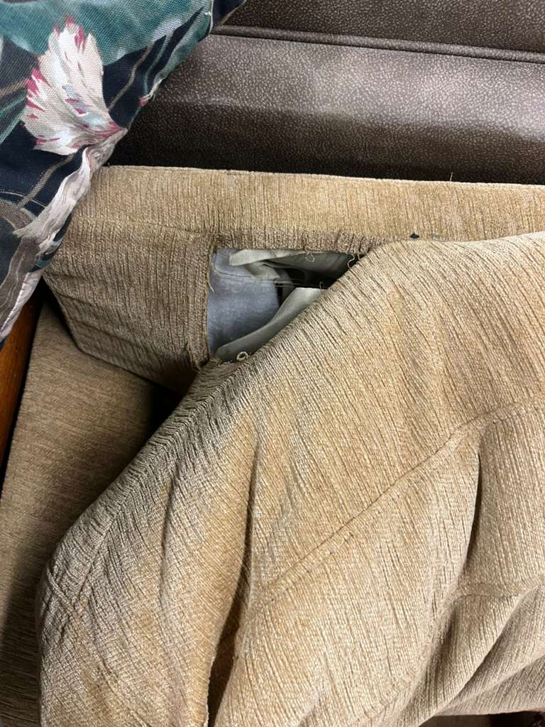 Tan Two Seat Sofa With Two Cushions - Rip in Upper Part of Couch - Price Reflects Damage