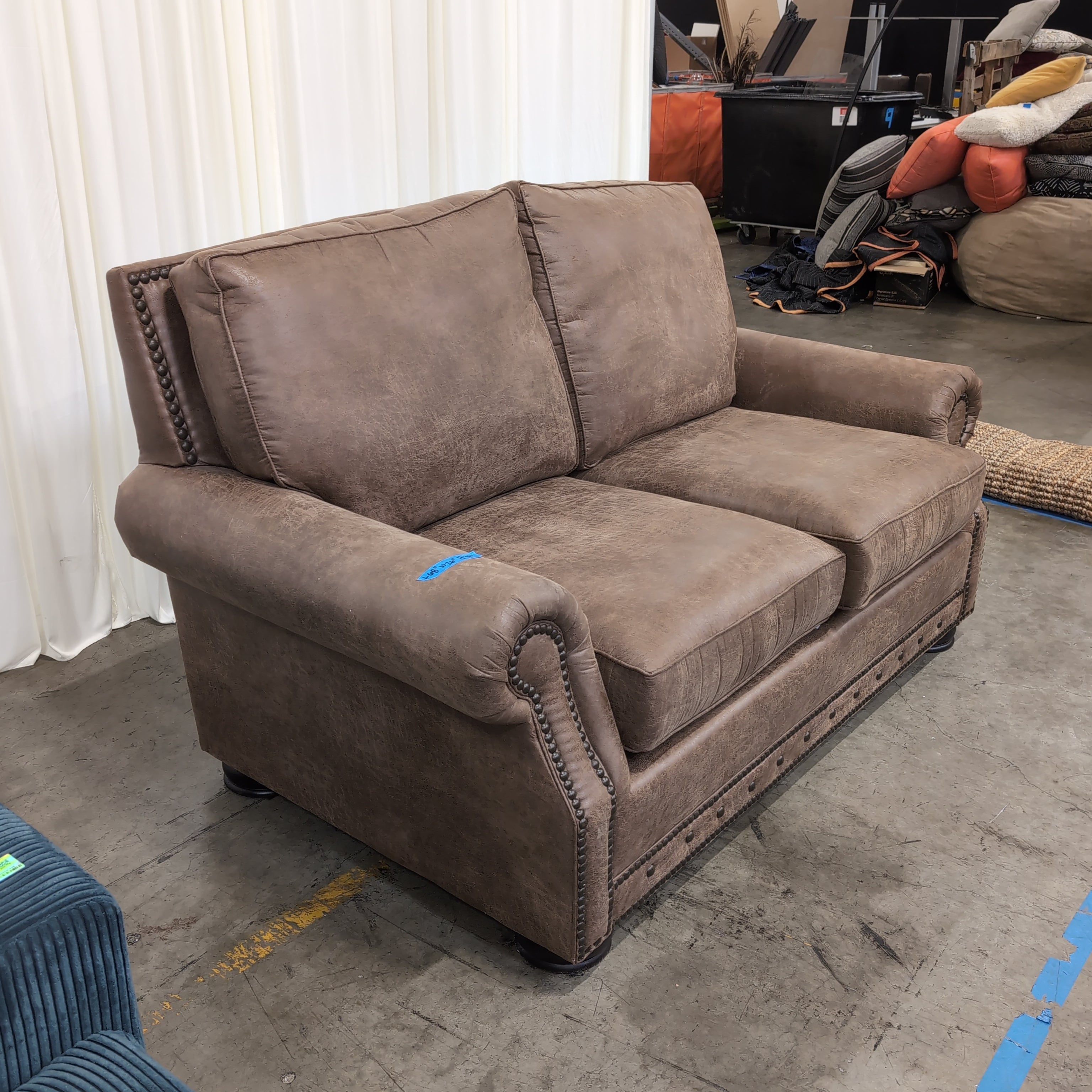 Tan Faux Leather Rolled Arm Loveseat with Nailhead Trim