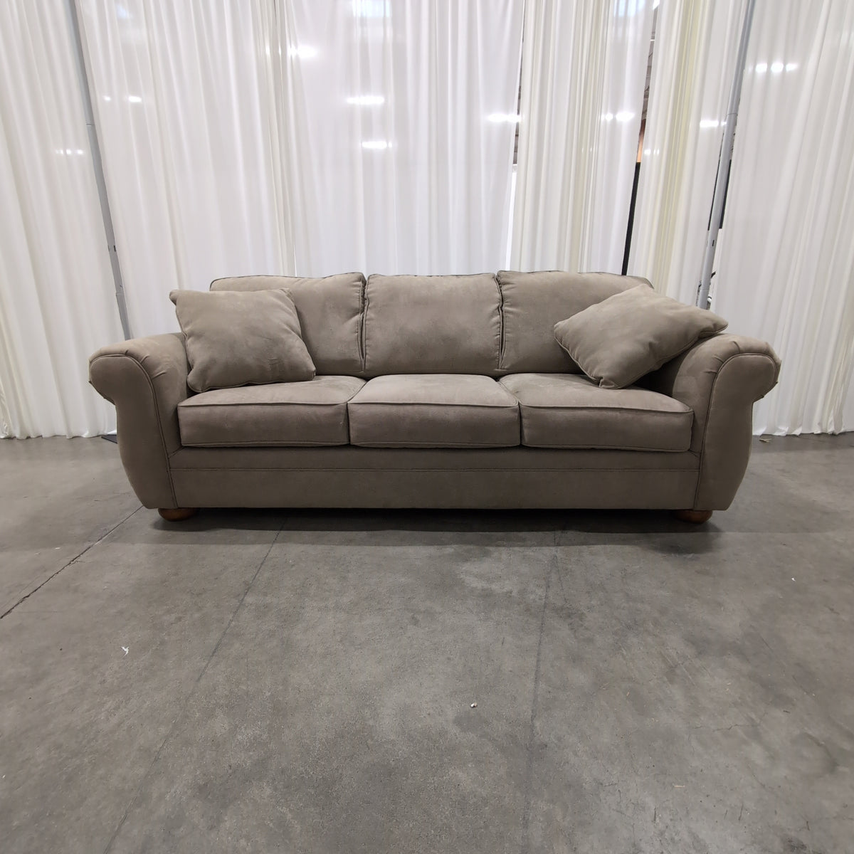 Beige Upholstered Three-Seat Couch with Rolled Arms