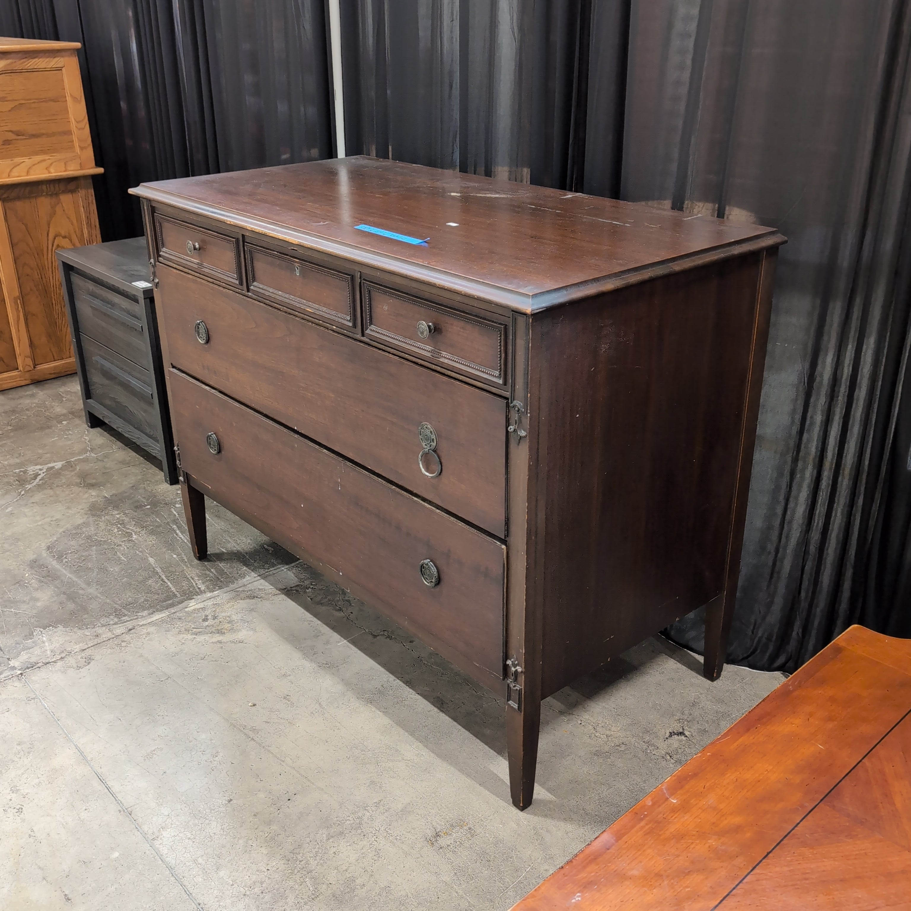 Dark Wood Three-Drawer Dresser with Recessed Panels