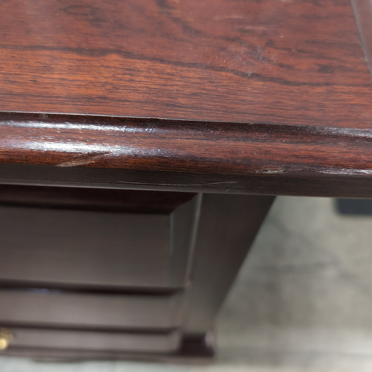 Dark Wood Three-Drawer Nightstand with Ornate Hardware