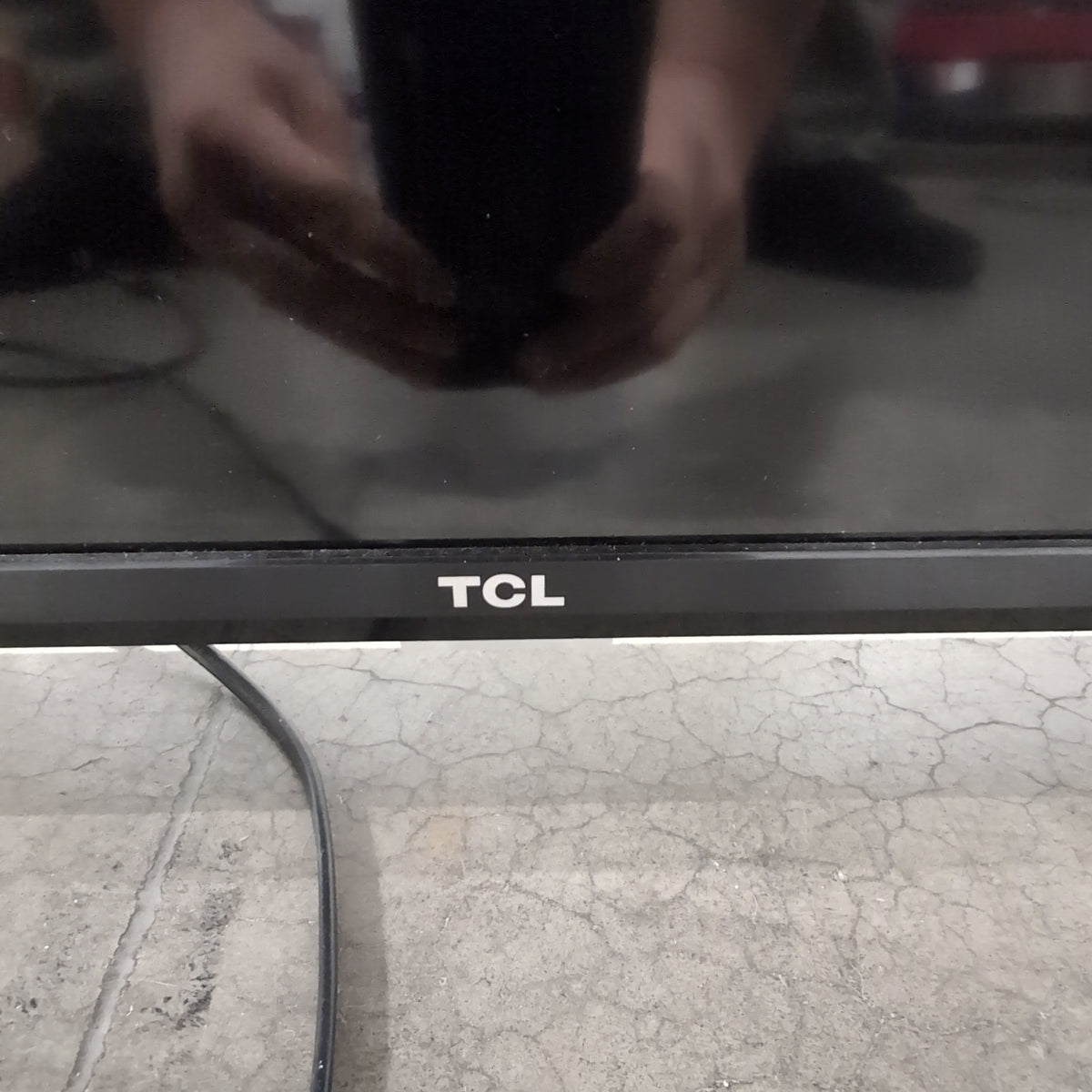 Black TCL Flat-Screen TV with Stand